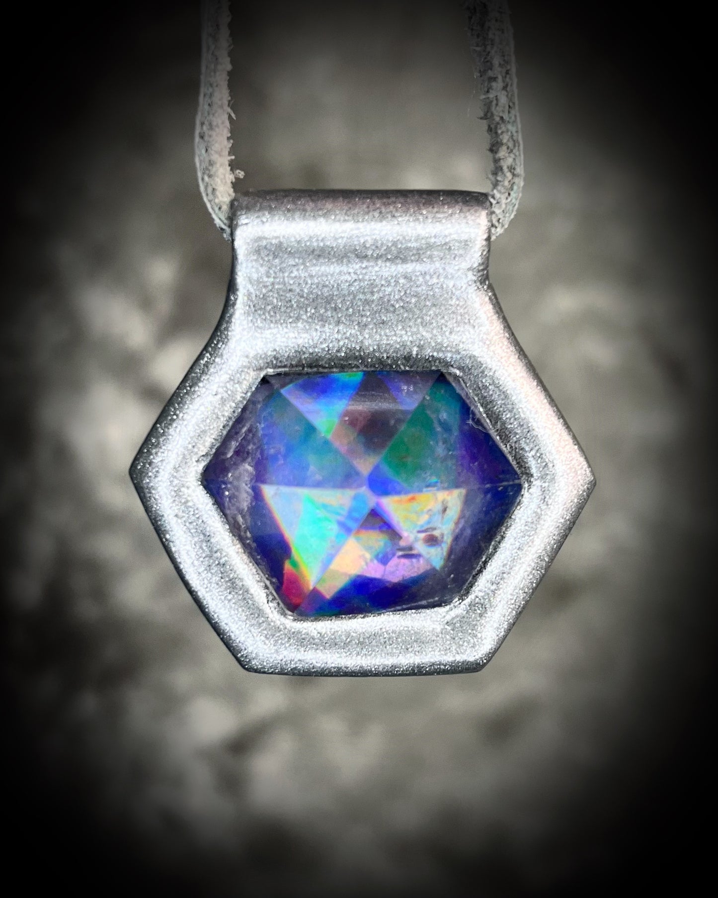 Iridescent aura black rainbow quartz crystal pendant in silver hanging from grey leather, chunky gemstone jewelry gift for her. David Bowie inspired jewelry.  