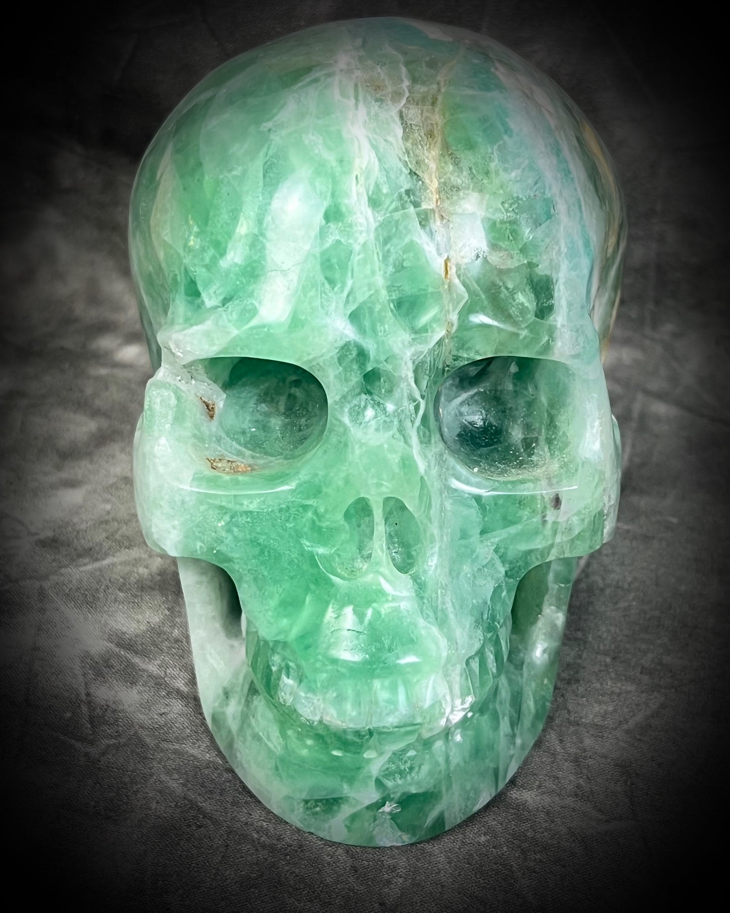  Large 5-inch green fluorite crystal skull with layered green bands and polished carved features. Manifestation altar holiday gift.