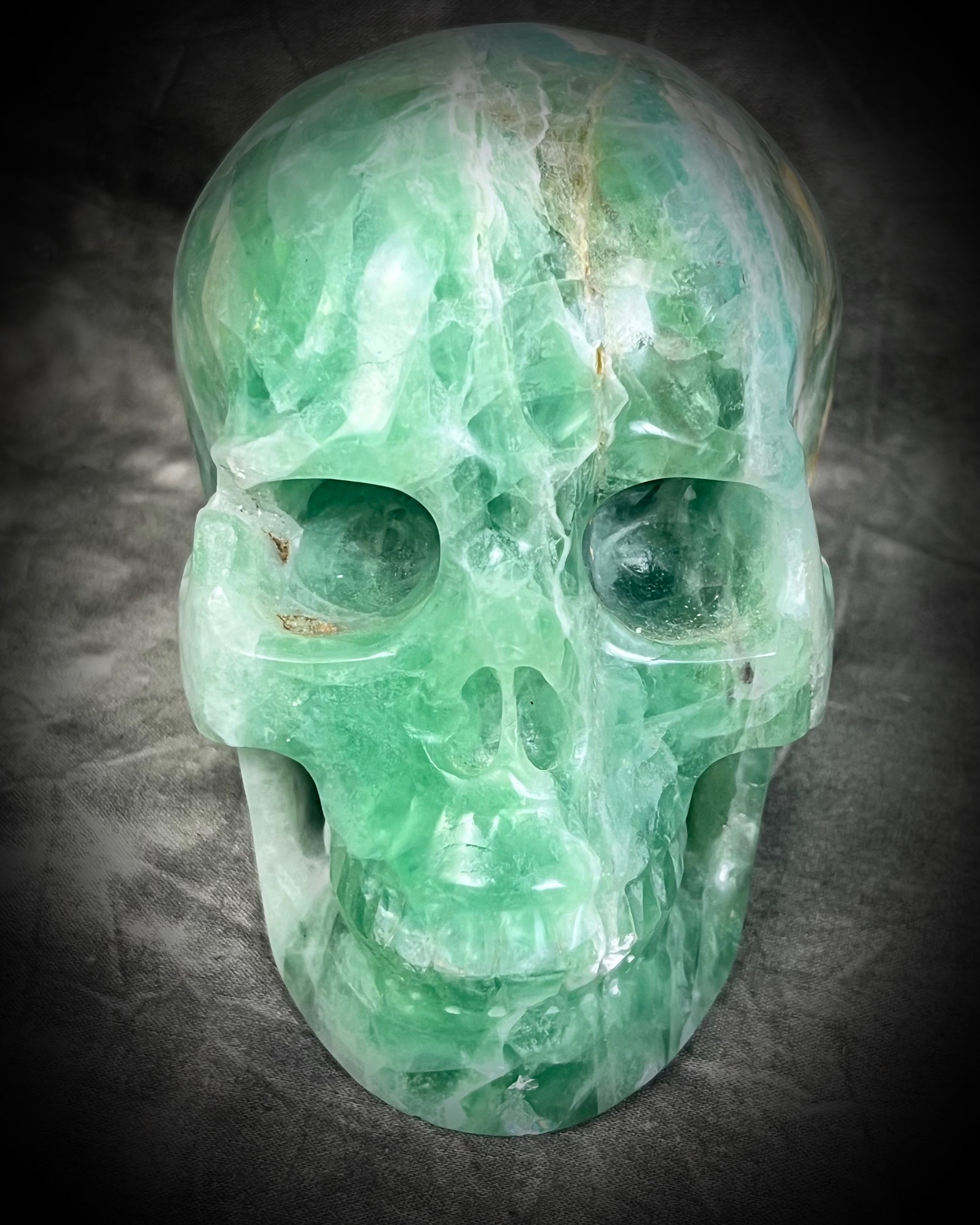  Large 5-inch green fluorite crystal skull with layered green bands and polished carved features. Manifestation altar holiday gift.