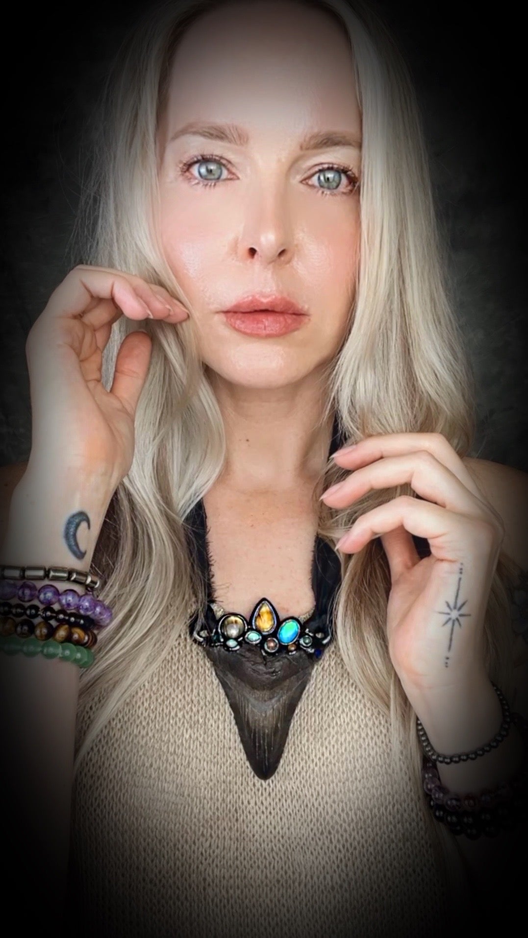 Large megalodon tooth necklace crowned with citrine, opal, black opal, labradorite, dioptase, golden tourmaline, lapis lazuli, and moonstone — set in black and hung from recycled silk ribbons.