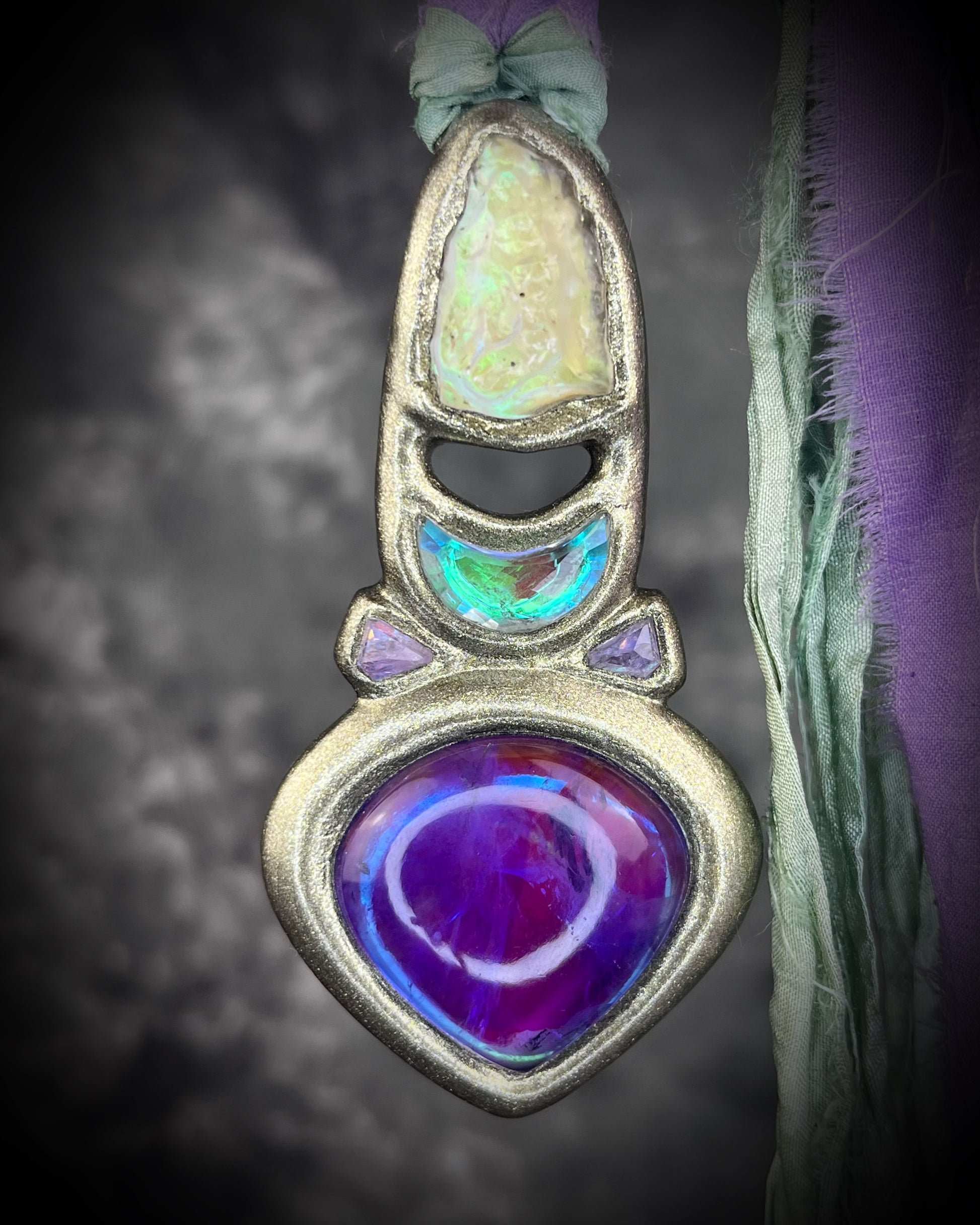 Libyan Desert Glass talisman with amethyst, prasiolite and lavender spinel on recycled silk, featuring shifting green, gold, pink and purple glow. Handmade by Become Spellbound.