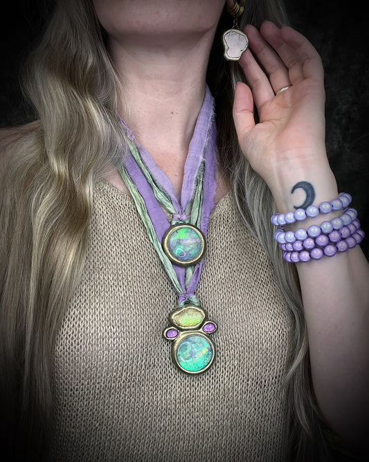 Libyan Desert Glass talisman with quartz crystal doublet, pink zircon crystals, and lilac and sea green recycled silk ties, handmade by Become Spellbound, Baltimore Magazine Best of Baltimore 2026 Jewelry winner.