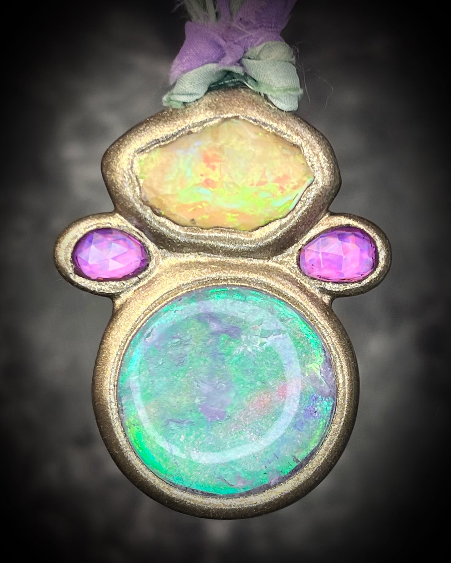 Libyan Desert Glass talisman with quartz crystal doublet, pink zircon crystals, and lilac and sea green recycled silk ties, handmade by Become Spellbound, Baltimore Magazine Best of Baltimore 2026 Jewelry winner.