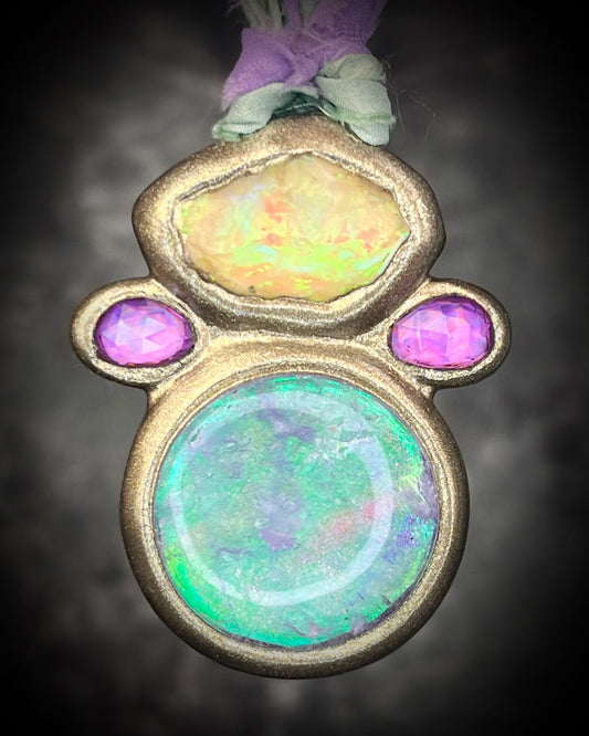 Libyan Desert Glass talisman with quartz crystal doublet, pink zircon crystals, and lilac and sea green recycled silk ties, handmade by Become Spellbound, Baltimore Magazine Best of Baltimore 2026 Jewelry winner.