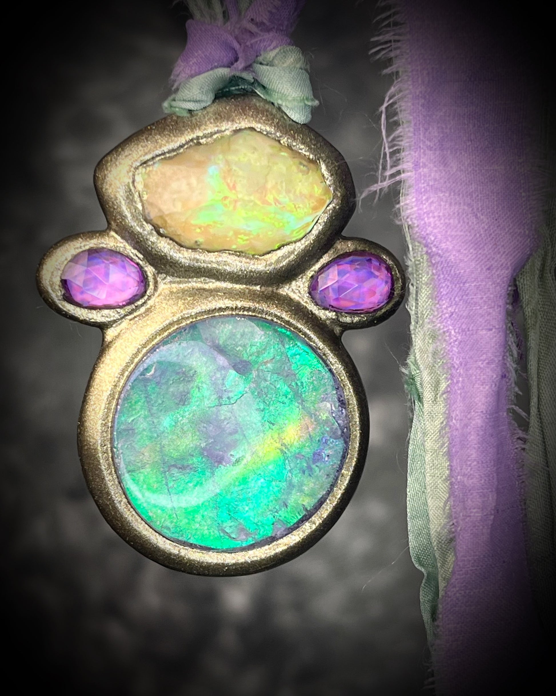 Libyan Desert Glass talisman with quartz crystal doublet, pink zircon crystals, and lilac and sea green recycled silk ties, handmade by Become Spellbound, Baltimore Magazine Best of Baltimore 2026 Jewelry winner.