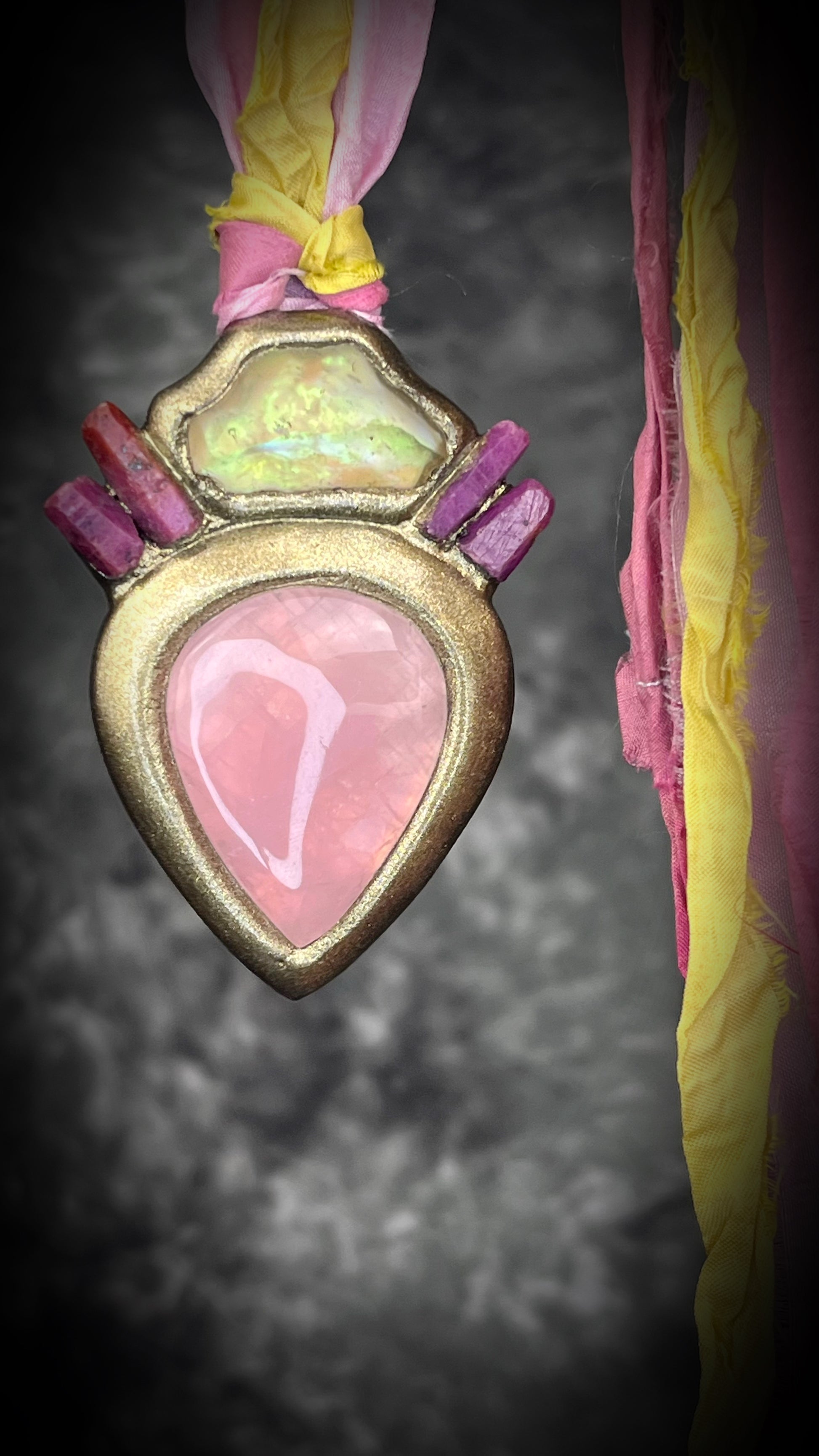 Libyan Desert Glass talisman with raw ruby crystals, rose quartz, and pink and yellow recycled silk ties by Become Spellbound, Baltimore Magazine Best of Baltimore 2026 Jewelry winner.