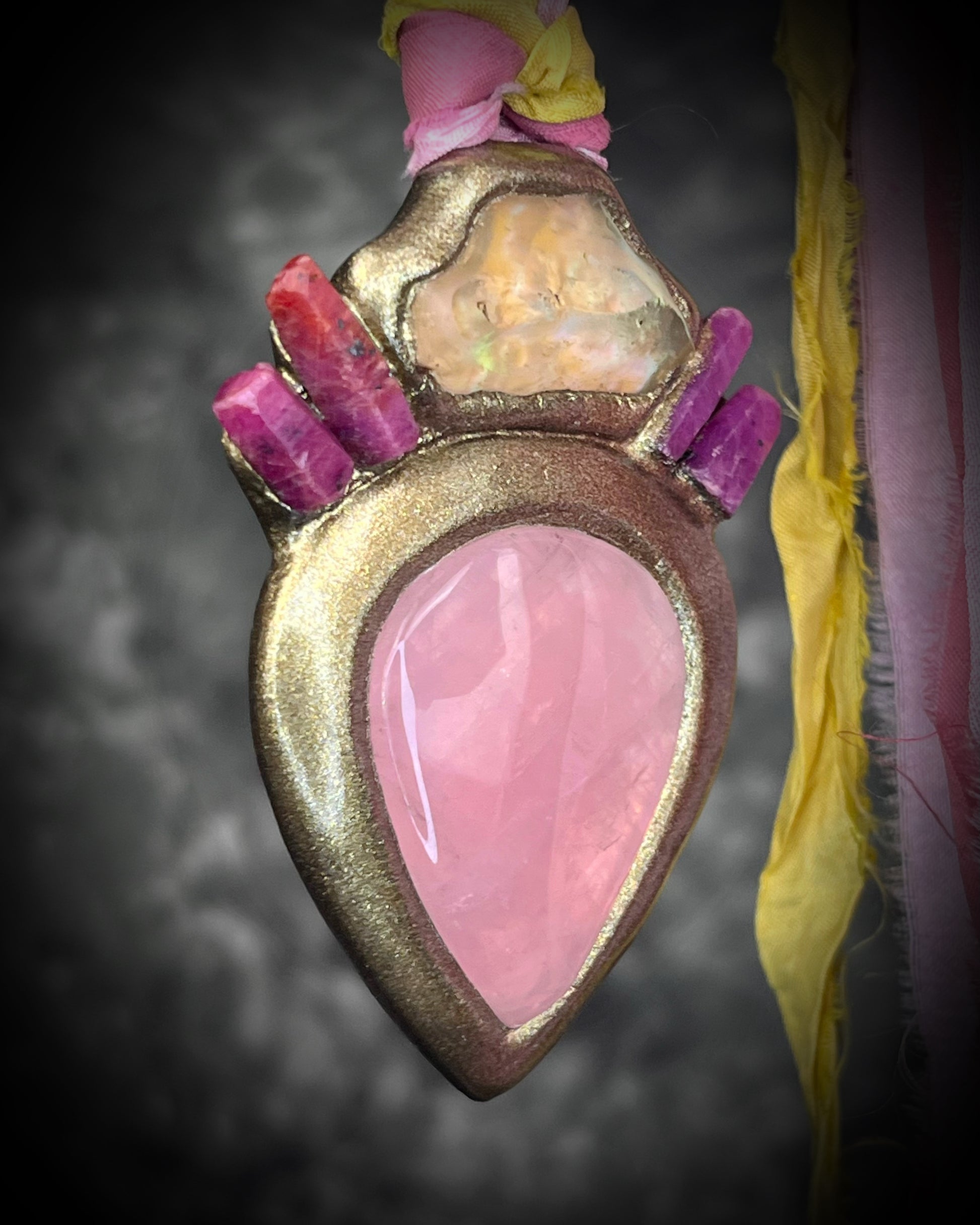 Libyan Desert Glass talisman with raw ruby crystals, rose quartz, and pink and yellow recycled silk ties by Become Spellbound, Baltimore Magazine Best of Baltimore 2026 Jewelry winner.