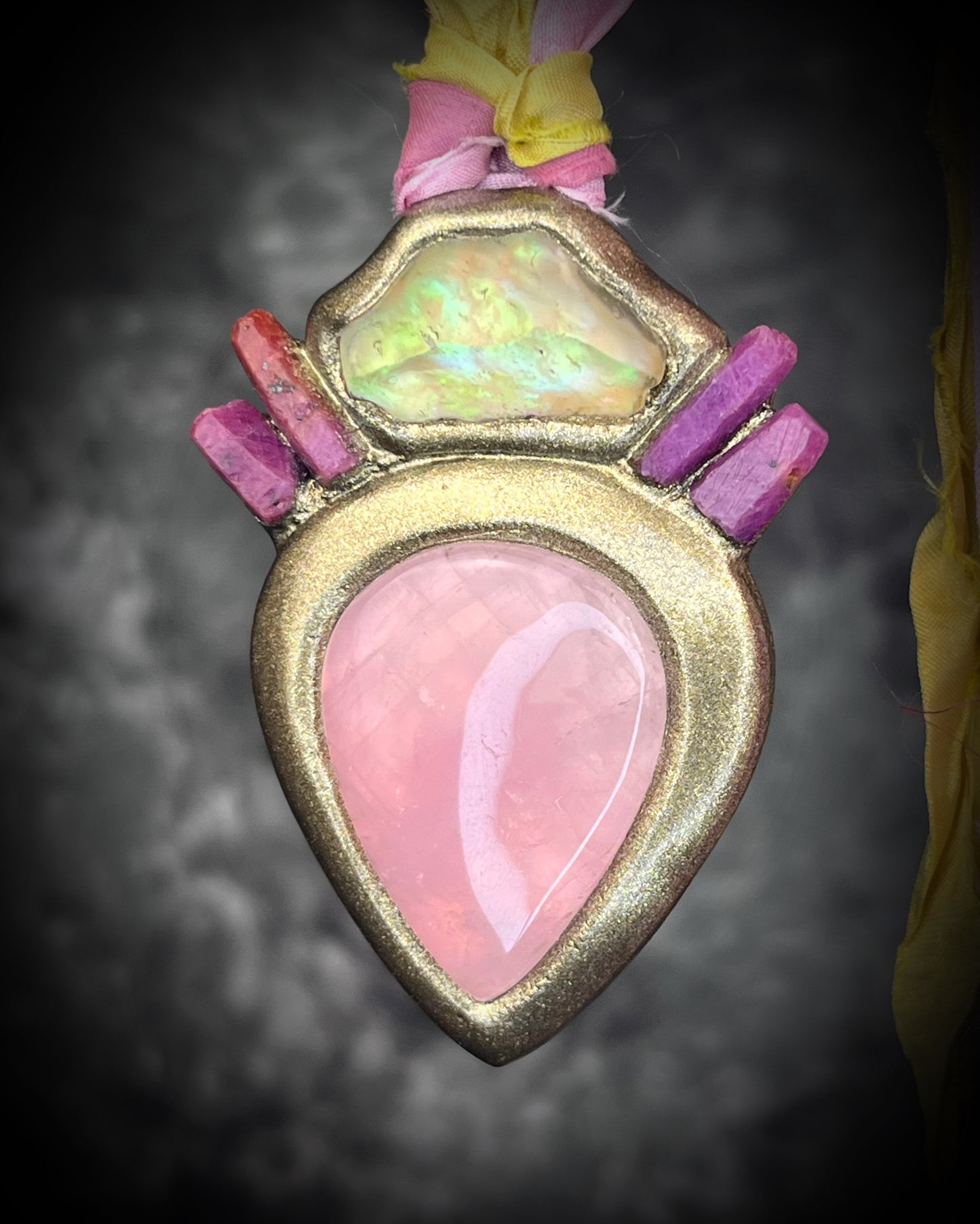 Libyan Desert Glass talisman with raw ruby crystals, rose quartz, and pink and yellow recycled silk ties by Become Spellbound, Baltimore Magazine Best of Baltimore 2026 Jewelry winner.