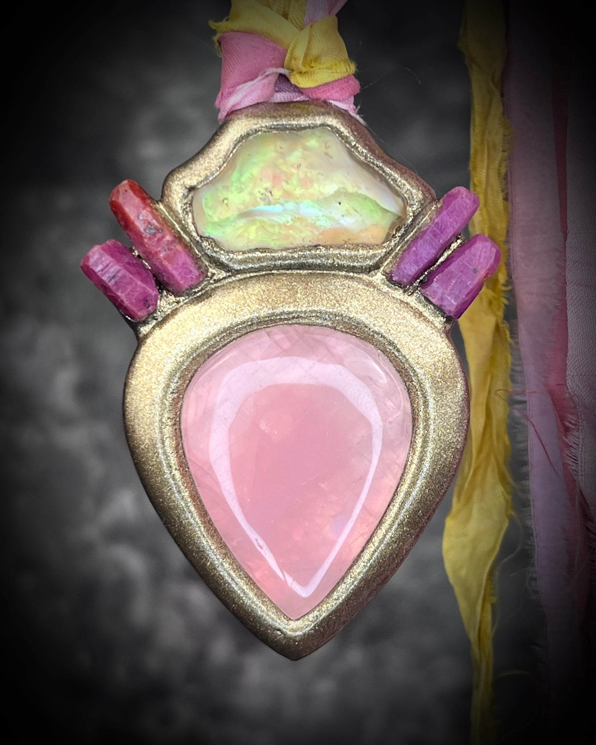Libyan Desert Glass talisman with raw ruby crystals, rose quartz, and pink and yellow recycled silk ties by Become Spellbound, Baltimore Magazine Best of Baltimore 2026 Jewelry winner.