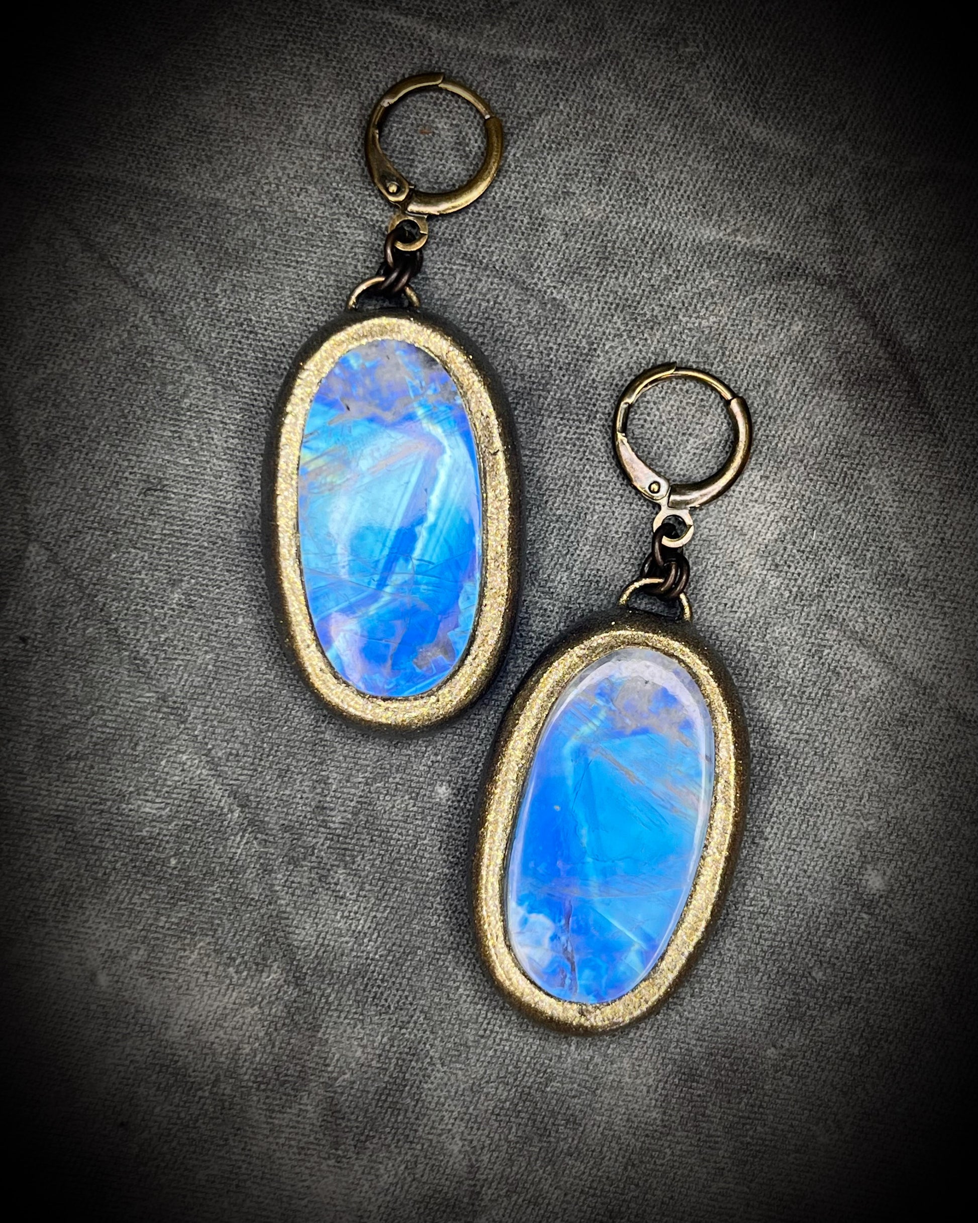 Luminous flashy rainbow moonstone earrings in gold finish hung from hypoallergenic brass huggie earring hooks. Goddess gift for her.