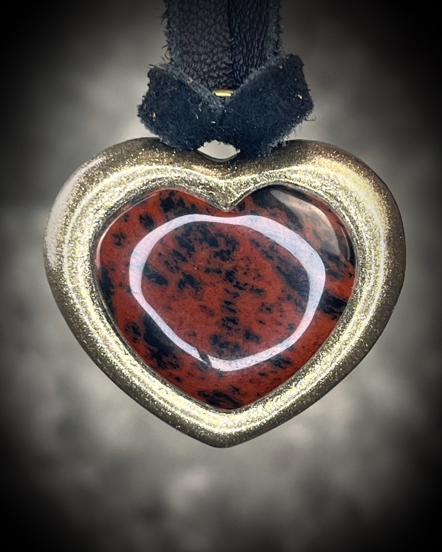 Mahogany obsidian heart pendant necklace in gold finish on black leather. Grounding protection crystal jewelry symbolizing strength and resilience. Gift for her.