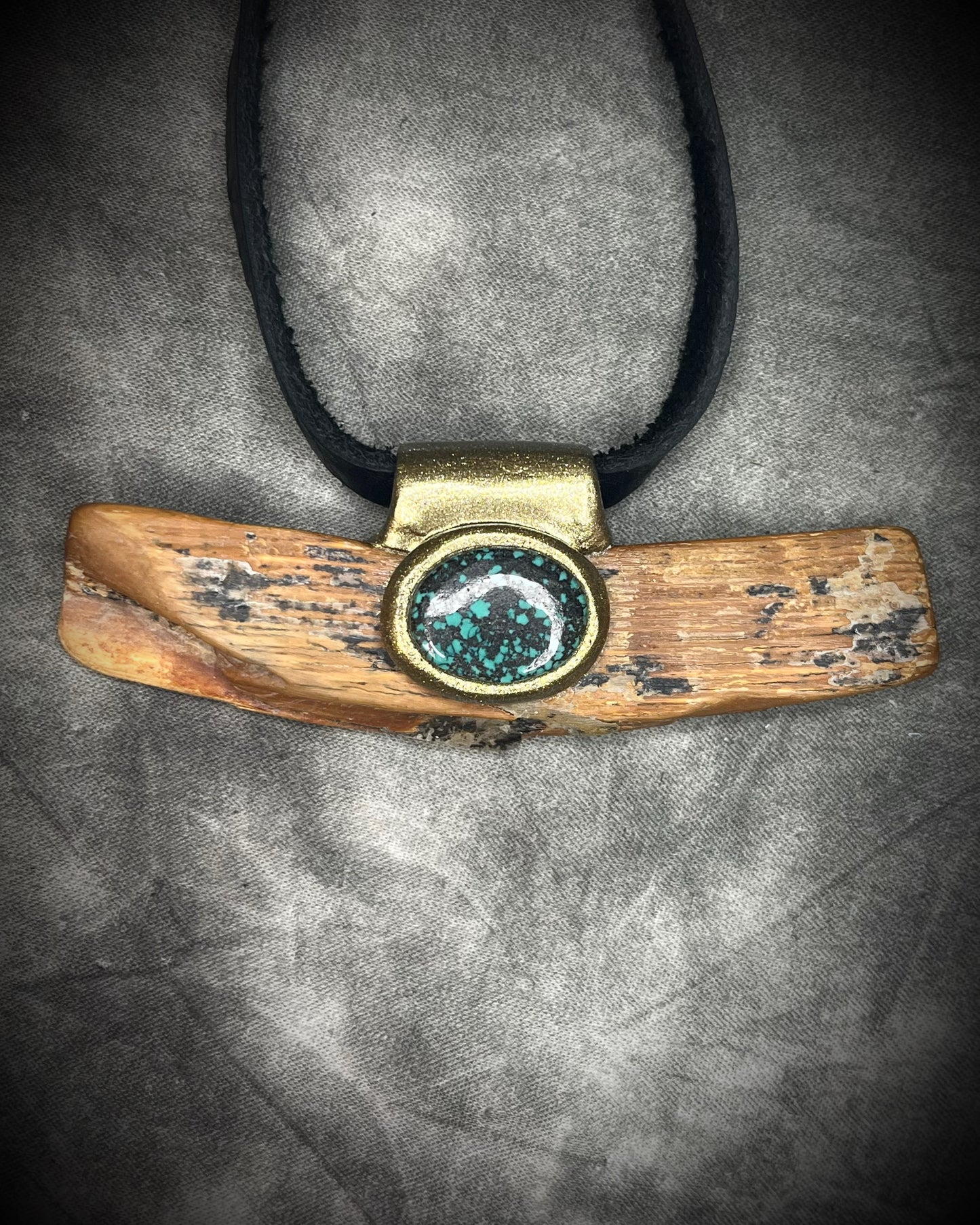 Mammoth tusk fossil and turquoise talisman on black leather, one-of-a-kind natural history jewelry handmade by Become Spellbound in Baltimore, Maryland.