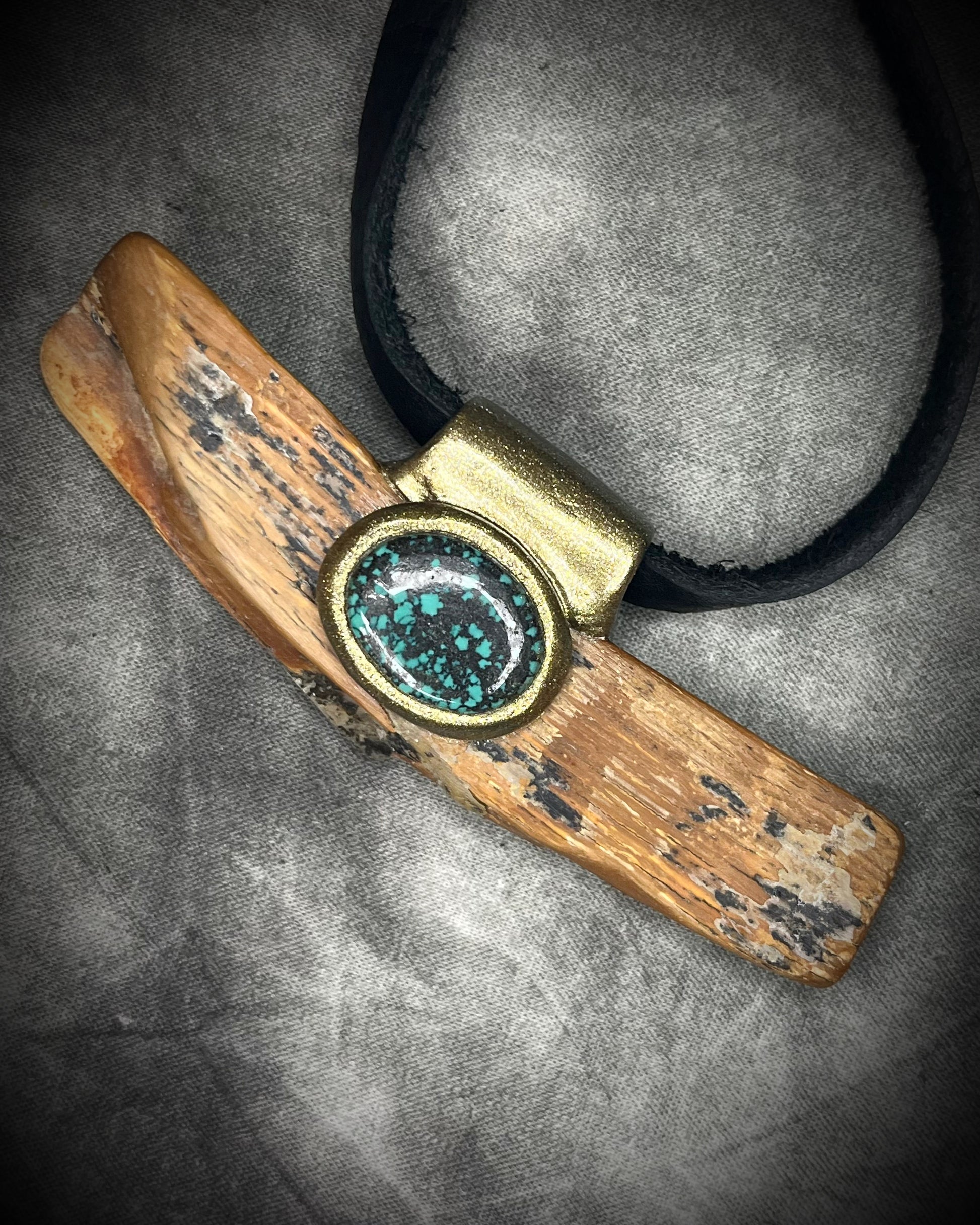 Mammoth tusk fossil and turquoise talisman on black leather, one-of-a-kind natural history jewelry handmade by Become Spellbound in Baltimore, Maryland.