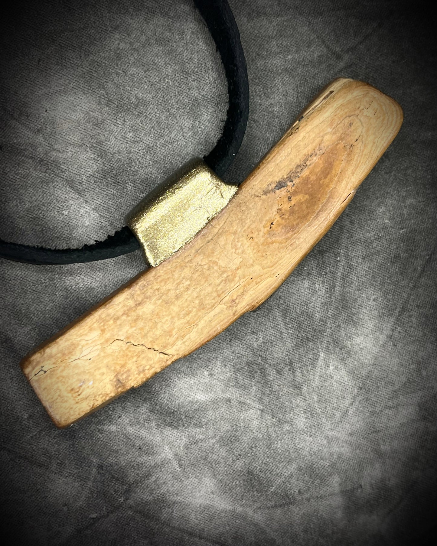 Mammoth tusk fossil and turquoise talisman on black leather, one-of-a-kind natural history jewelry handmade by Become Spellbound in Baltimore, Maryland.