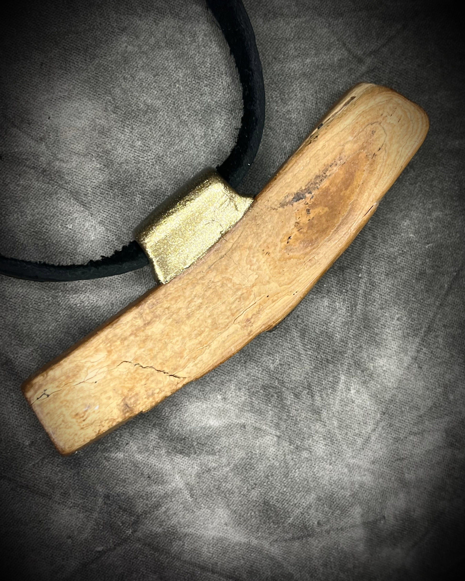 Mammoth tusk fossil and turquoise talisman on black leather, one-of-a-kind natural history jewelry handmade by Become Spellbound in Baltimore, Maryland.