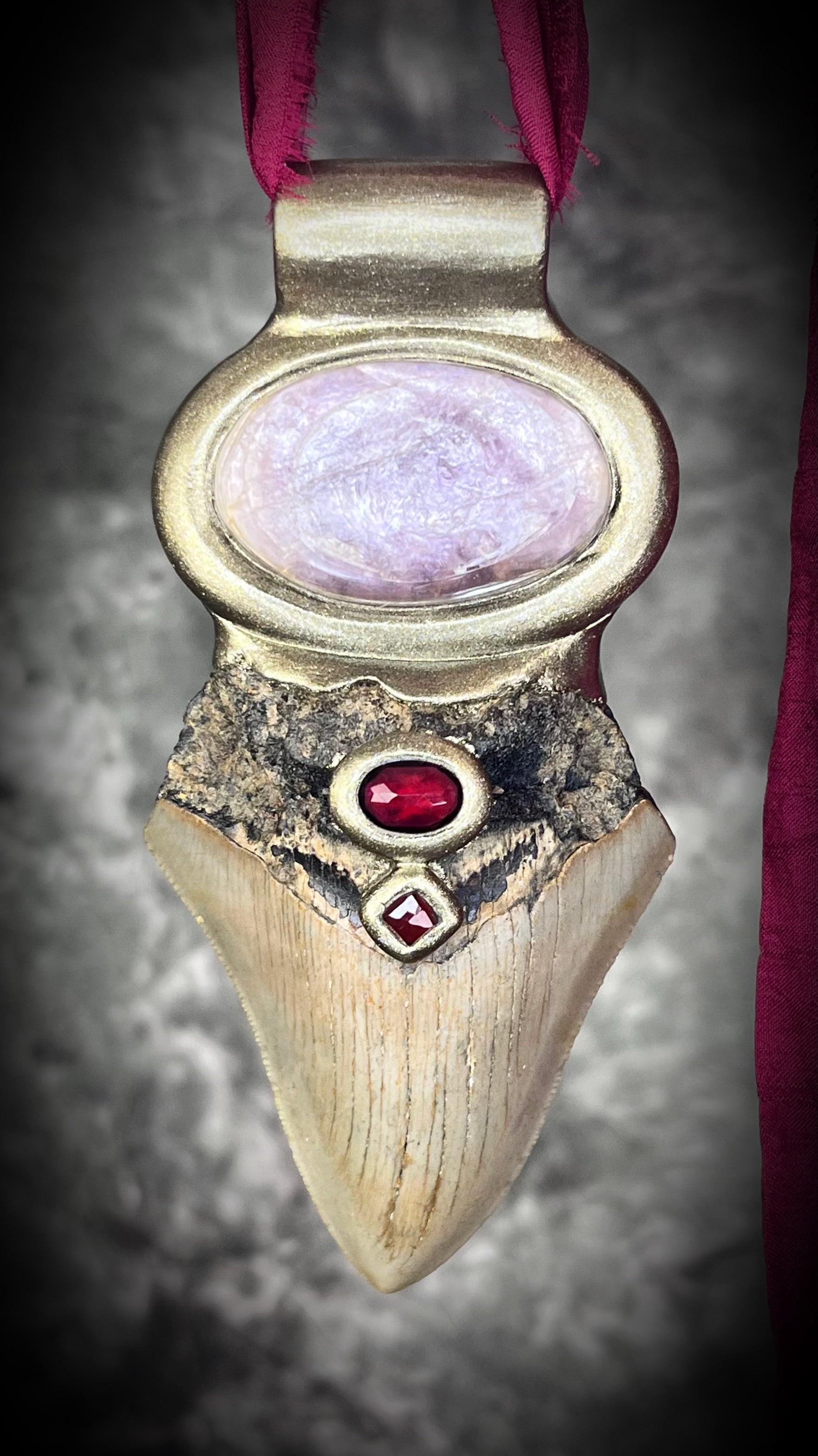 Megalodon fossil and gemstone necklace featuring garnet and lepidolite on black silk — bold witchy jewelry with grounding and healing energy.