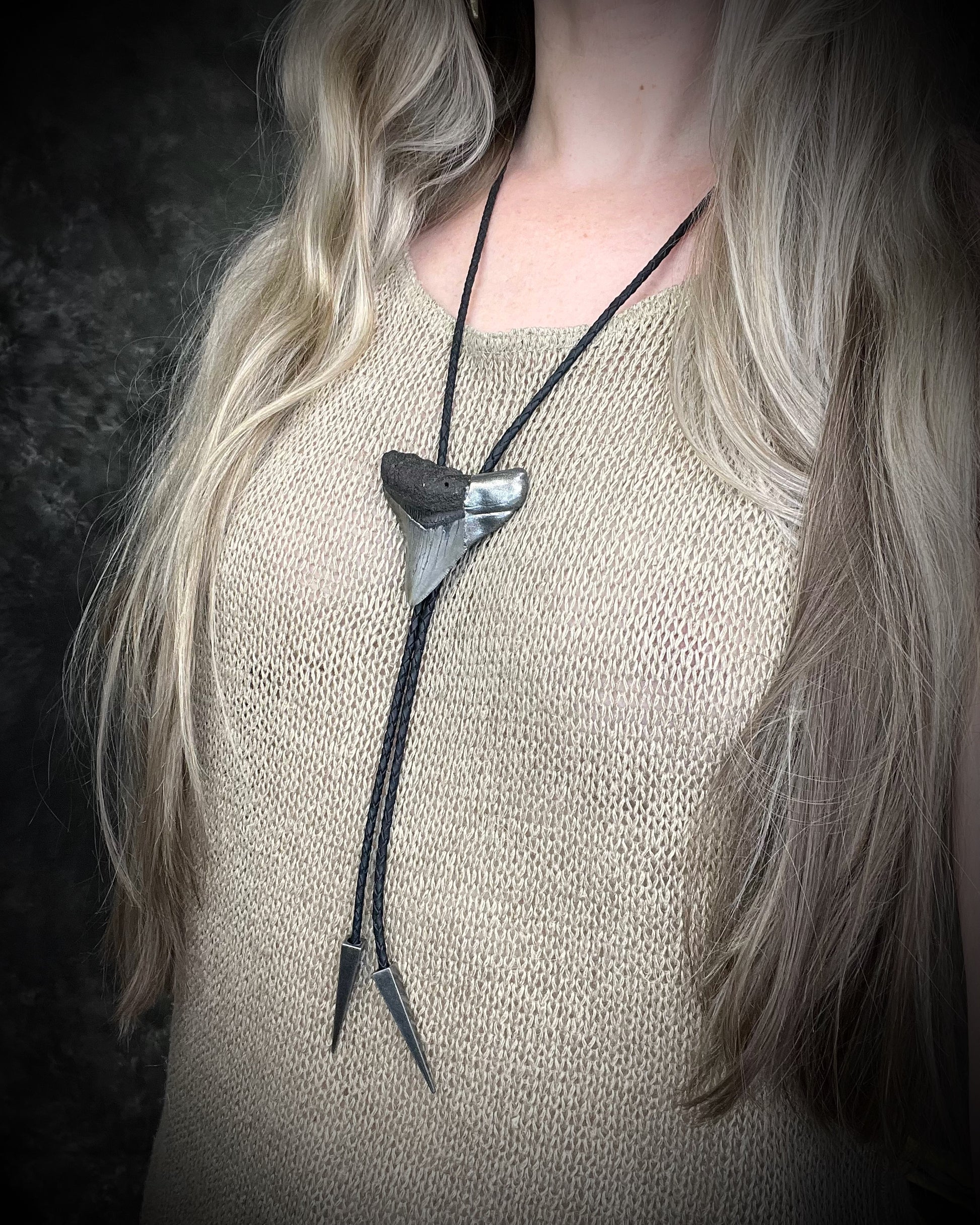 Megalodon fossil shark tooth bolo tie with gunmetal silver spike tips and clasp on black leather, Western-inspired fossil statement jewelry handmade in Baltimore Maryland. 