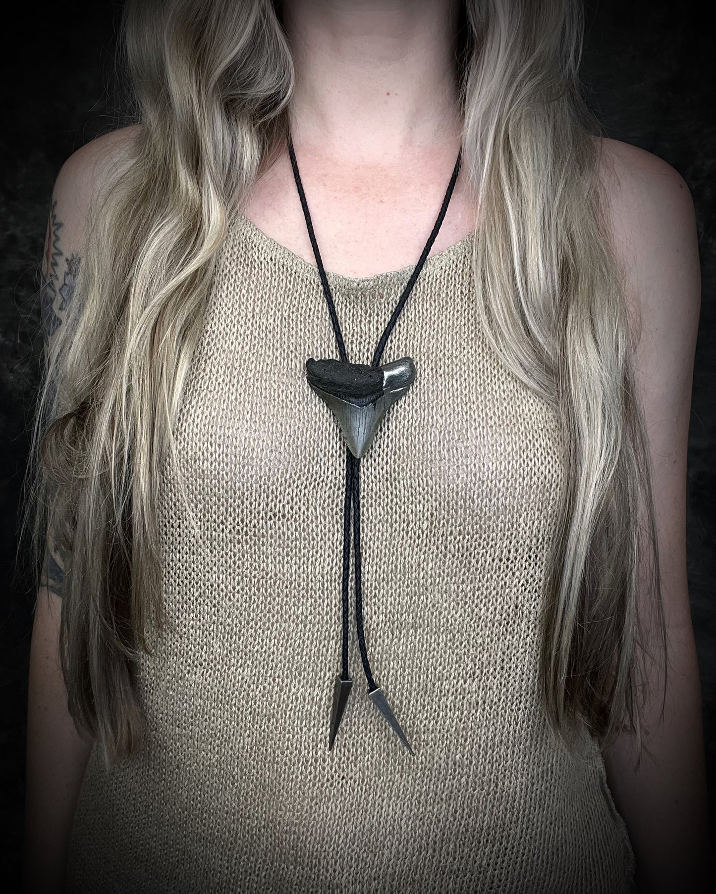 Megalodon fossil shark tooth bolo tie with gunmetal silver spike tips and clasp on black leather, Western-inspired fossil statement jewelry handmade in Baltimore Maryland. 
