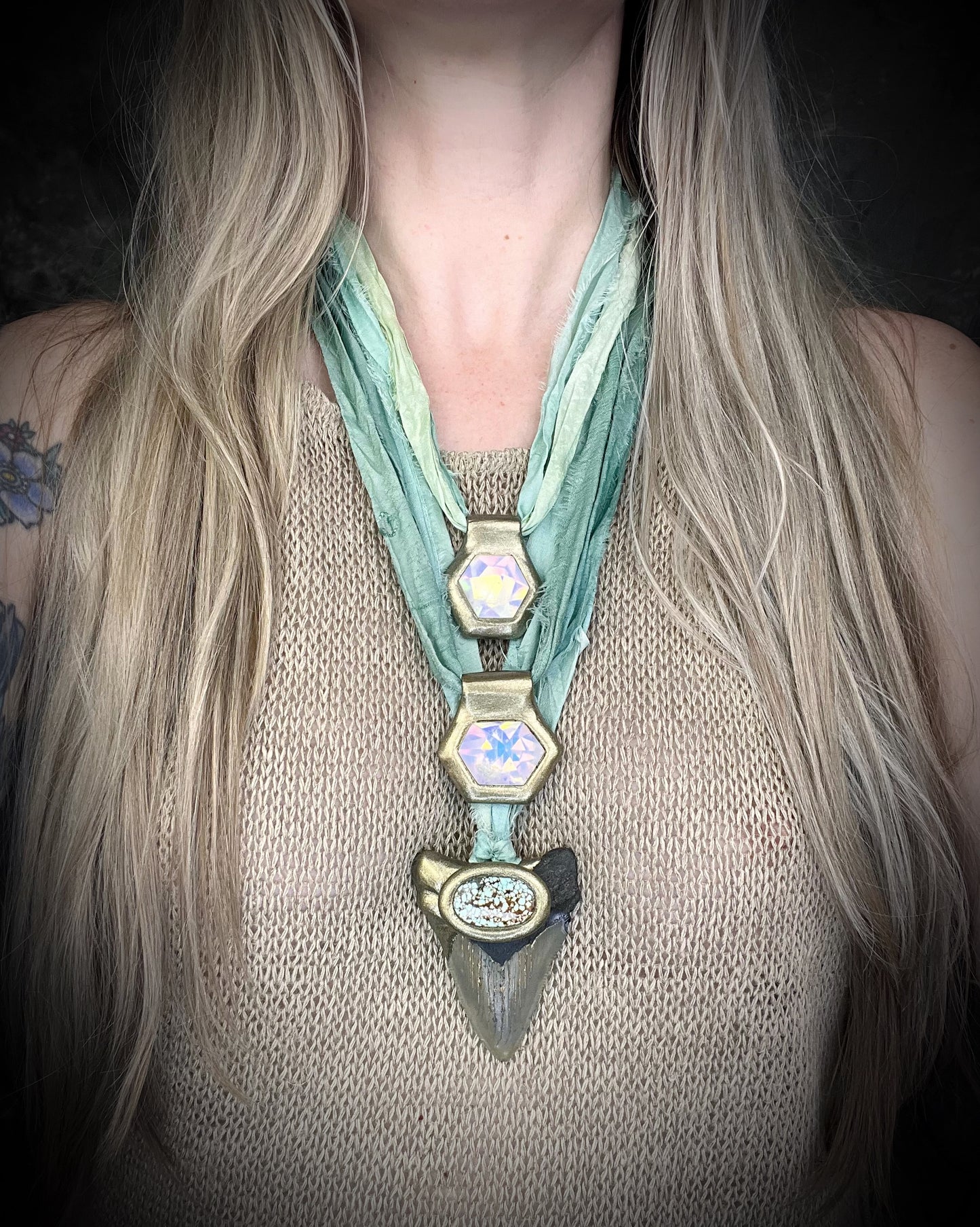 Megalodon fossil shark tooth talisman with aqua turquoise crystal, handmade shark tooth necklace on sea green recycled silk. Shown here layered with opalescent quartz necklaces. 