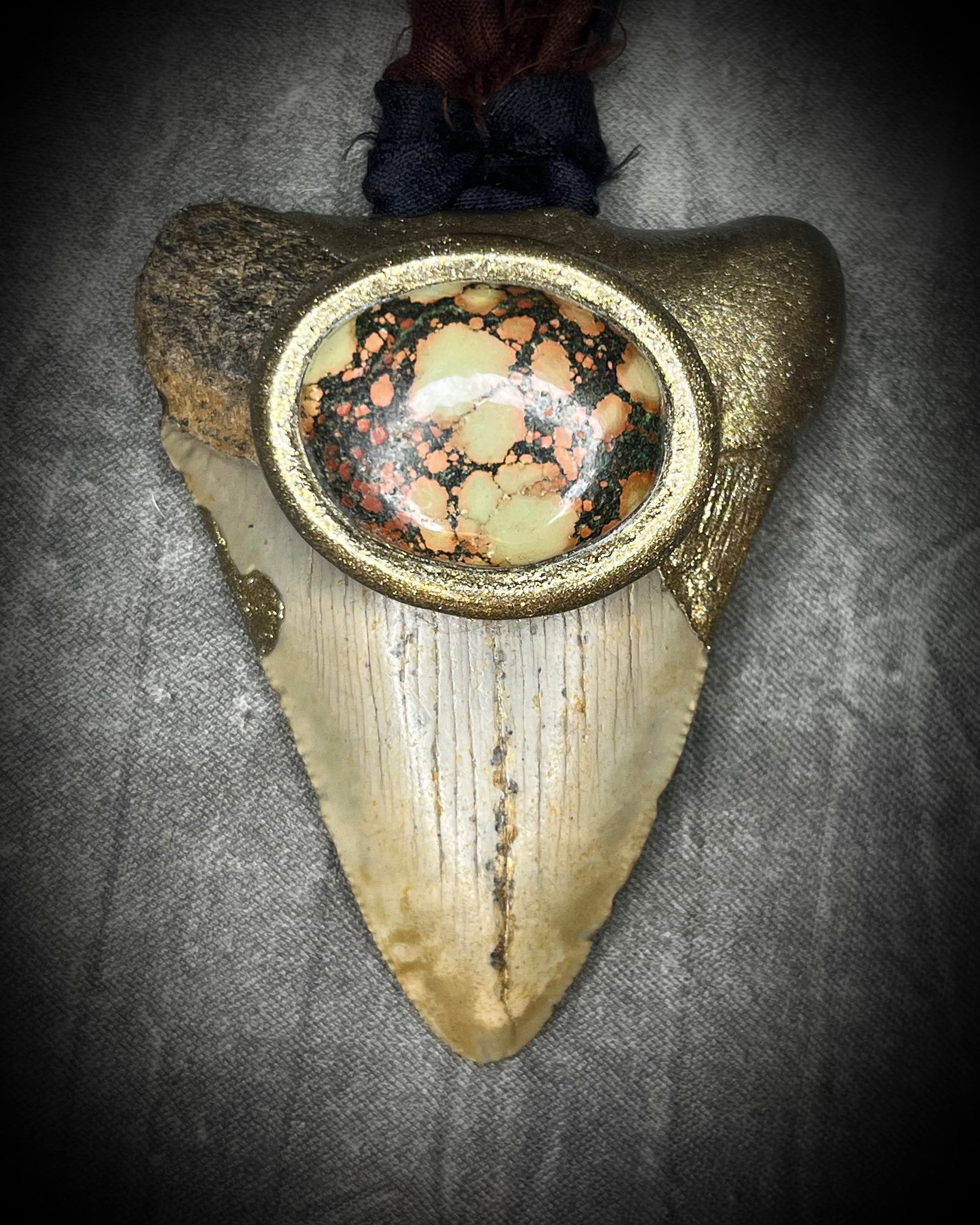 Megalodon fossil tooth talisman with earth-toned turquoise in moss green, orange and burgundy-red, gold finish, and black and brown recycled silk.