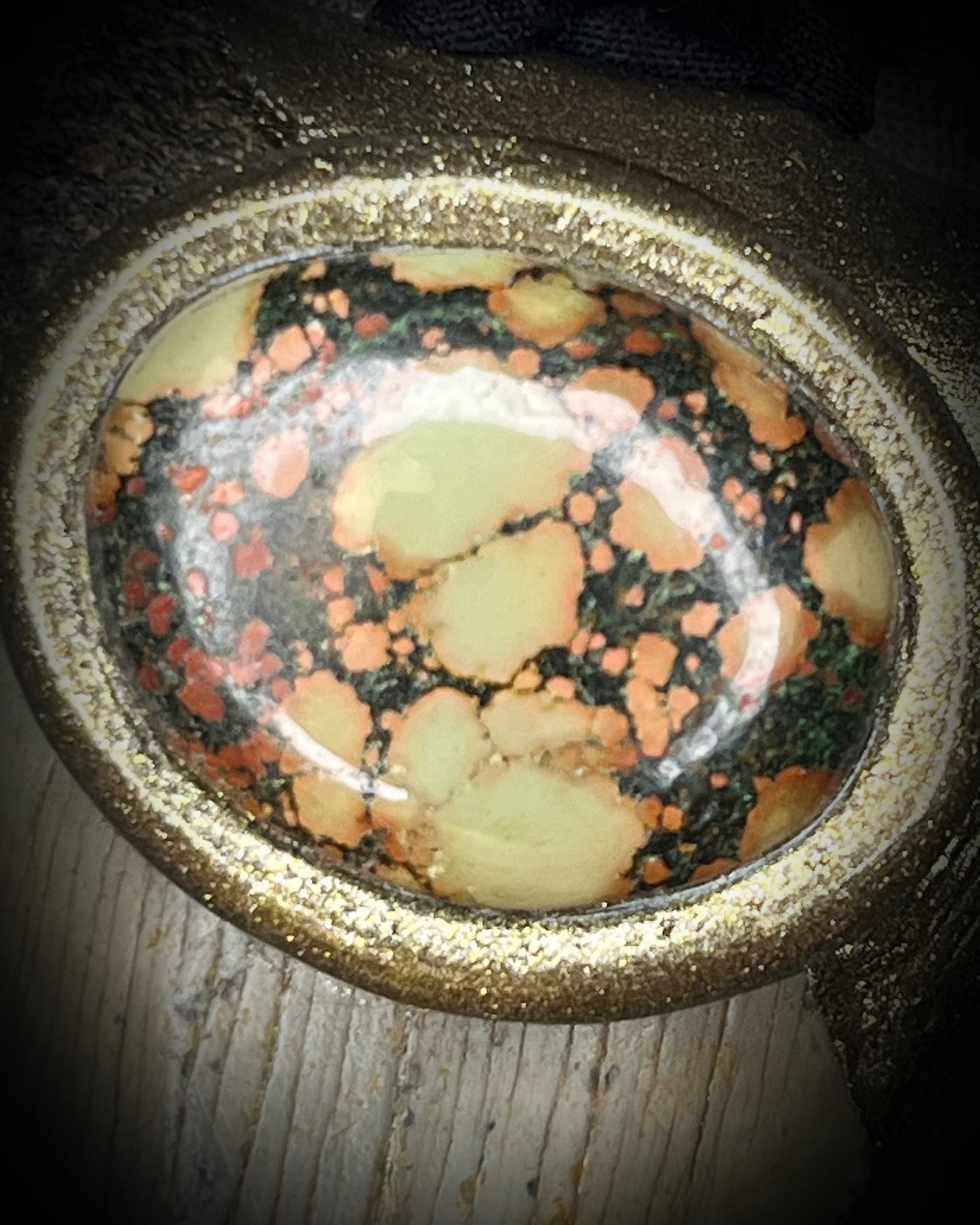 Megalodon fossil tooth talisman with earth-toned turquoise in moss green, orange and burgundy-red, gold finish, and black and brown recycled silk.