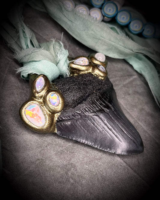 Megalodon shark tooth fossil handcrafted crystal talisman featuring opal gemstone and rainbow moonstones in gold, hung from recycled aqua silk. Beach wedding or summer jewelry photoshoot, cosplay, fantasy film costume or everyday enchantment!