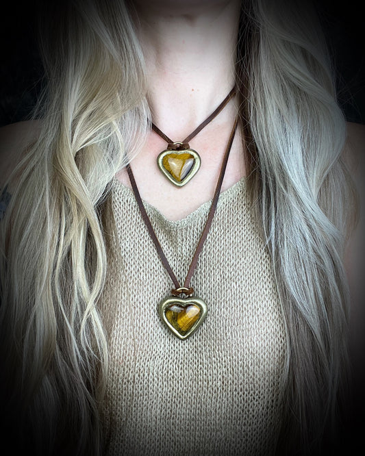 Model wearing layering necklaces- Tiger’s Eye crystal heart pendant necklaces with gold finish on brown leather cord — handmade grounding and protective jewelry. Holiday gift for her.