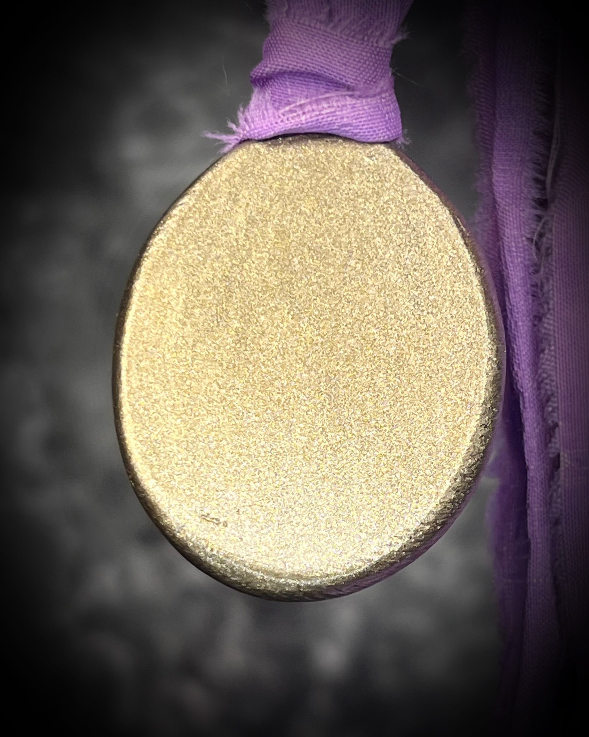 Mystical amethyst talisman with soft nebula glow, sculpted gold finish, and lilac recycled silk ties by Become Spellbound.