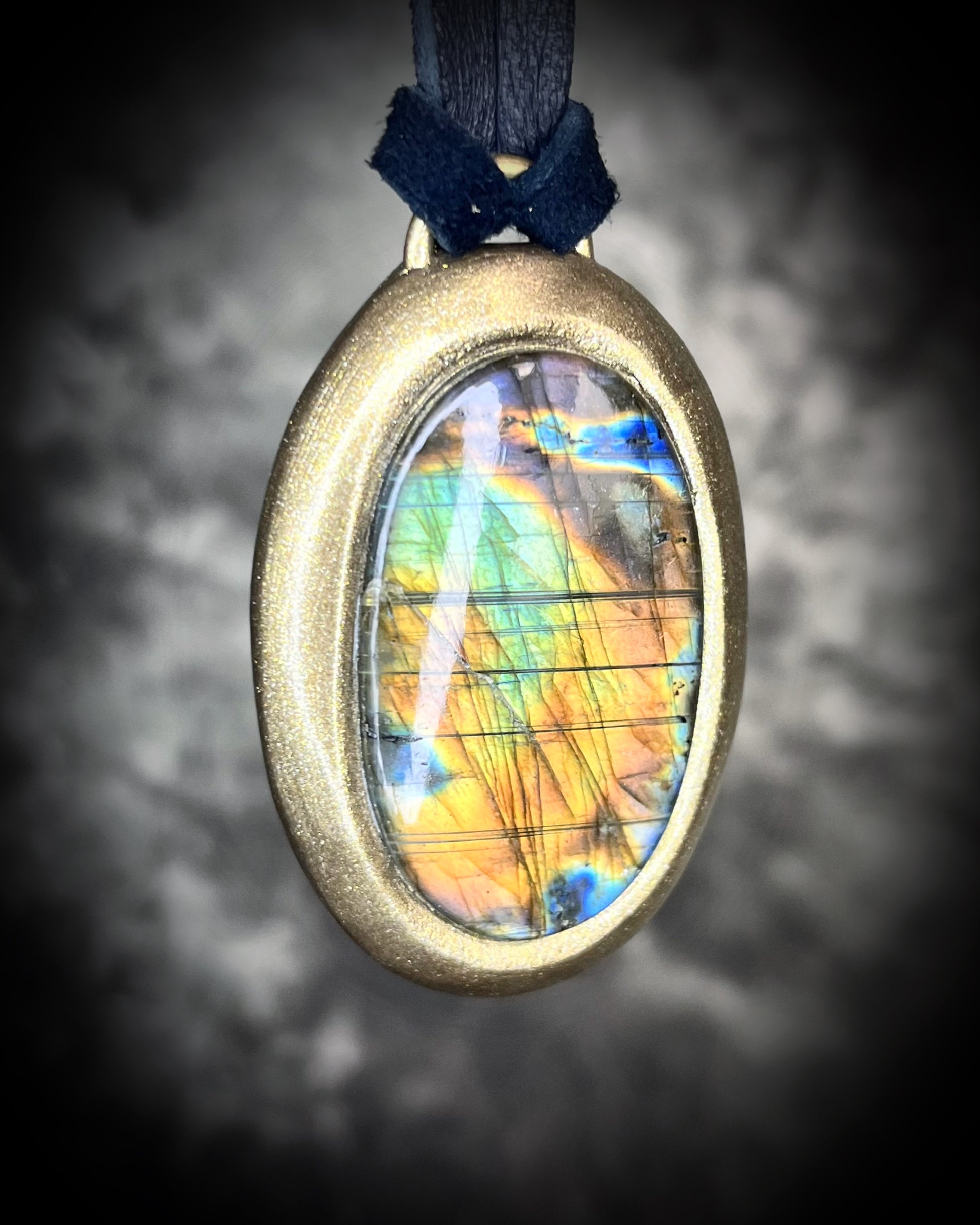 Mystical labradorite necklace on black leather cord, hand-sculpted artisan talisman with raw gemstone pendant, gothic crystal jewelry for spiritual style.