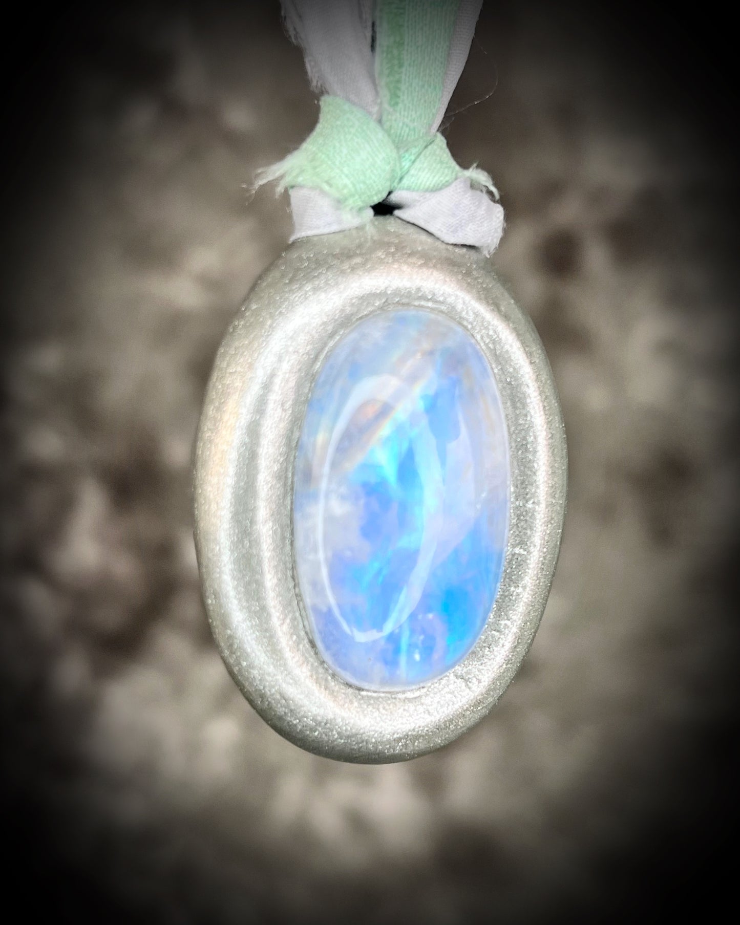 Mystical moonstone oval pendant in silver tone setting on recycled silk cord. Handmade crystal necklace for intuition, divine feminine energy, and spiritual connection. Unique gift for her, gemstone jewelry for meditation or daily wear.