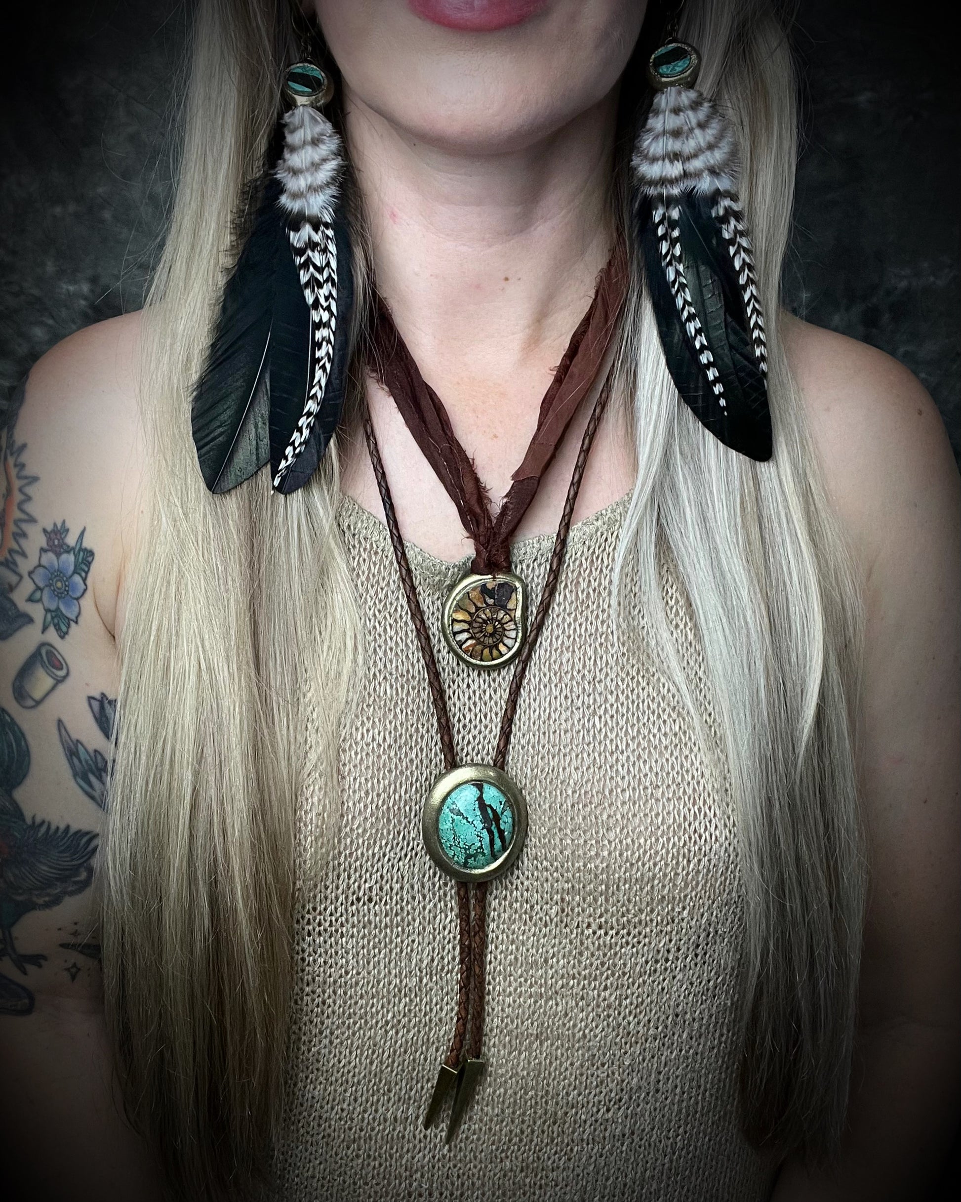 Natural turquoise bolo tie with distinctive double brown stripe resembling claw marks, brown leather, gold finish, and gold spike tips.