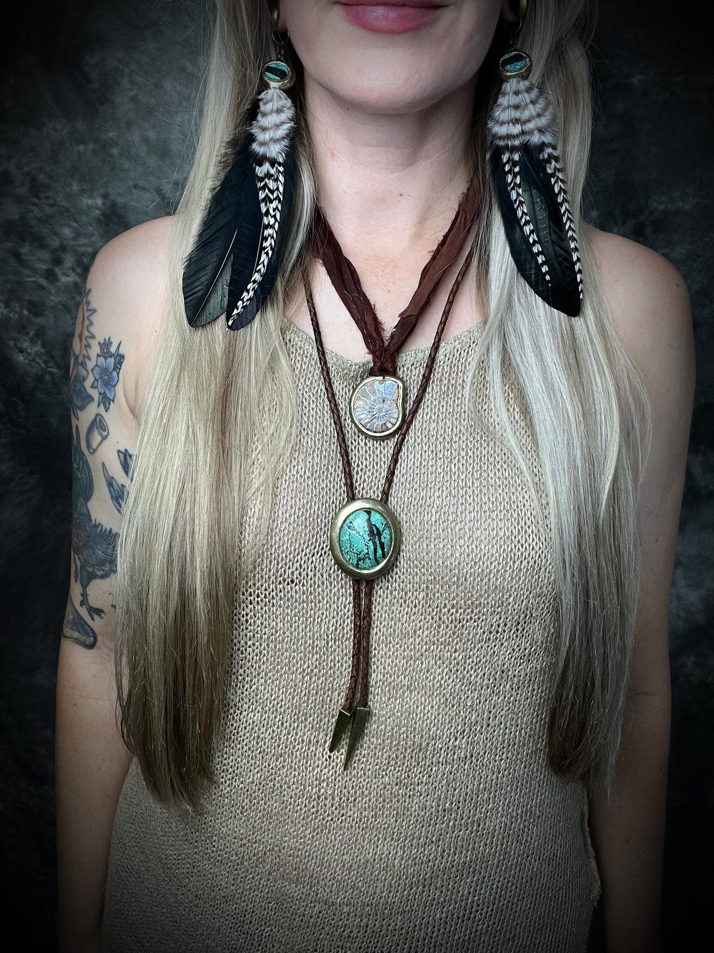 Natural turquoise bolo tie with distinctive double brown stripe resembling claw marks, brown leather, gold finish, and gold spike tips.