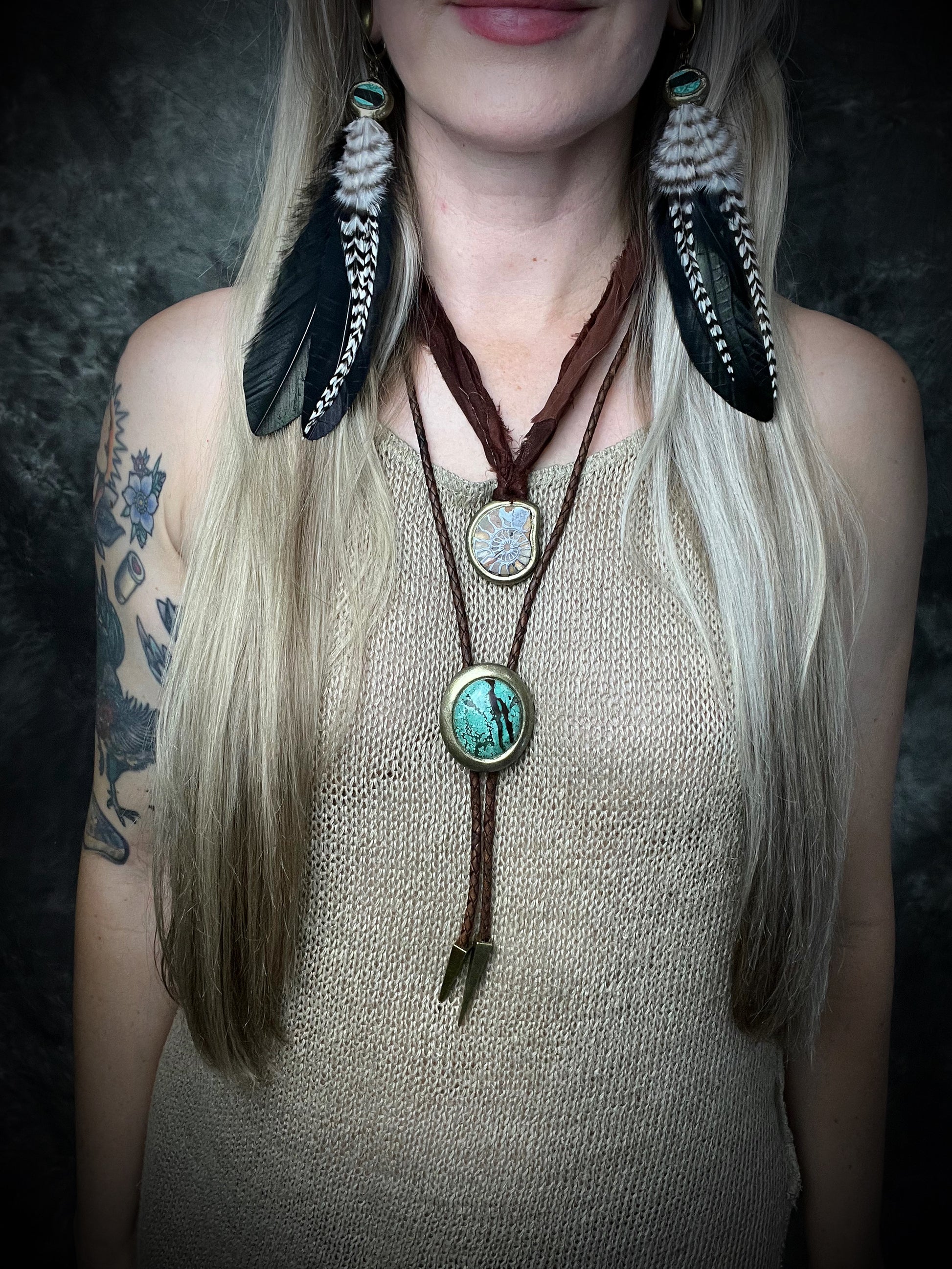 Natural turquoise bolo tie with distinctive double brown stripe resembling claw marks, brown leather, gold finish, and gold spike tips.