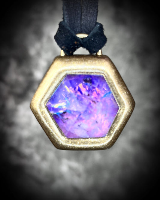 Opalescent amethyst hexagon pendant framed in gold on black leather cord — handmade mystical crystal talisman necklace.