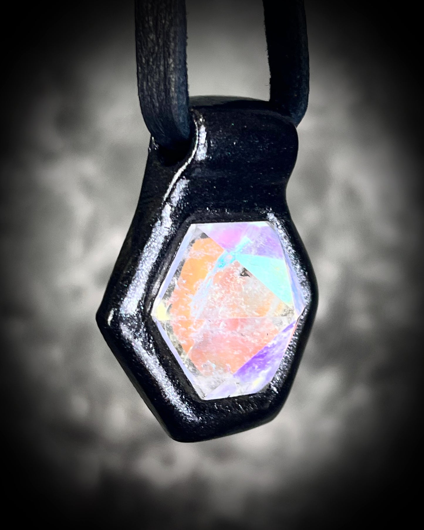 Opalescent quartz gemstone necklace with shimmering opal colors, bold gothic pendant on black leather, fantasy-inspired and witchy handmade jewelry.