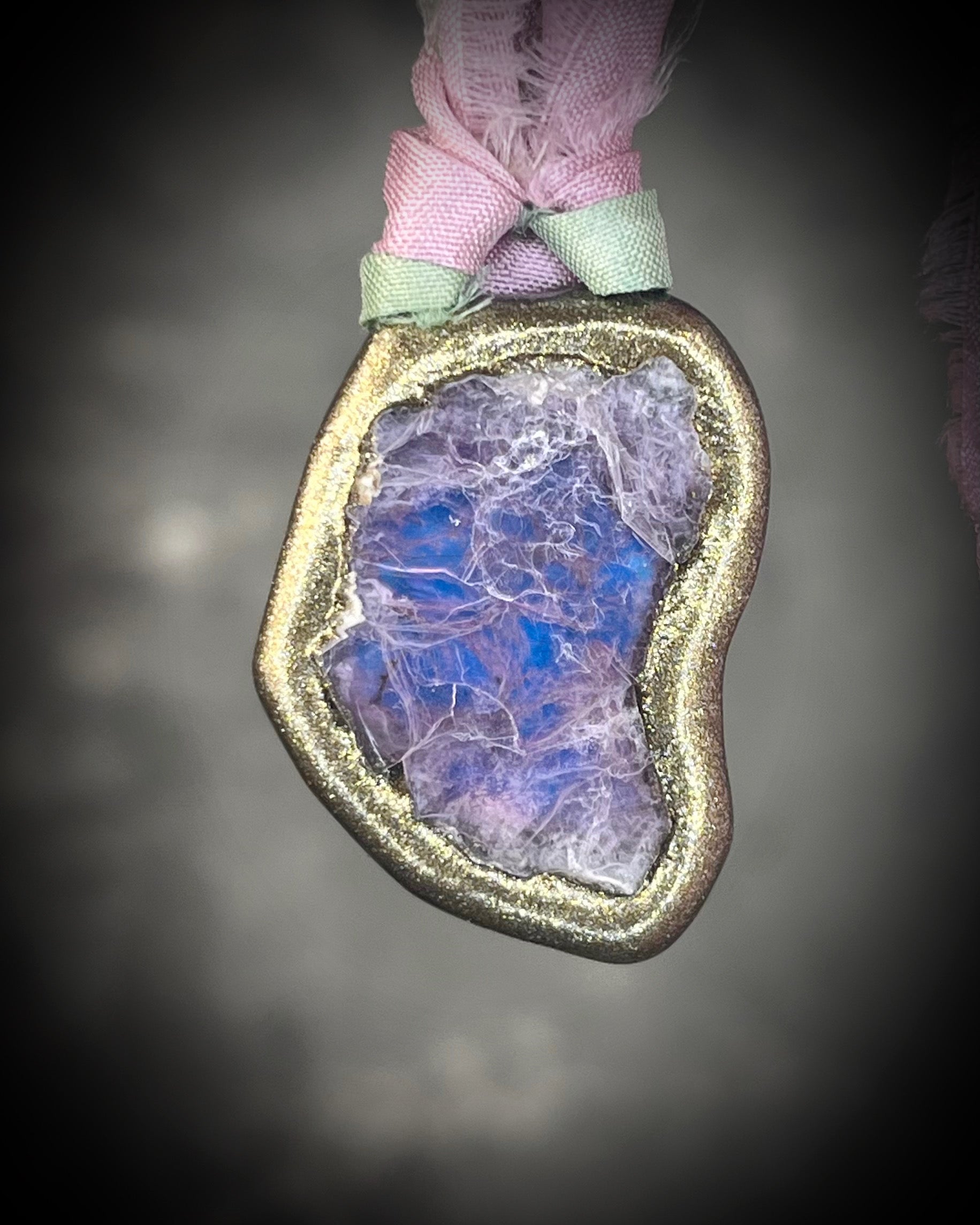 Organic lepidolite crystal talisman  pendant with sculpted gold finish and mint green and lilac recycled silk ties. Handmade by Become Spellbound.