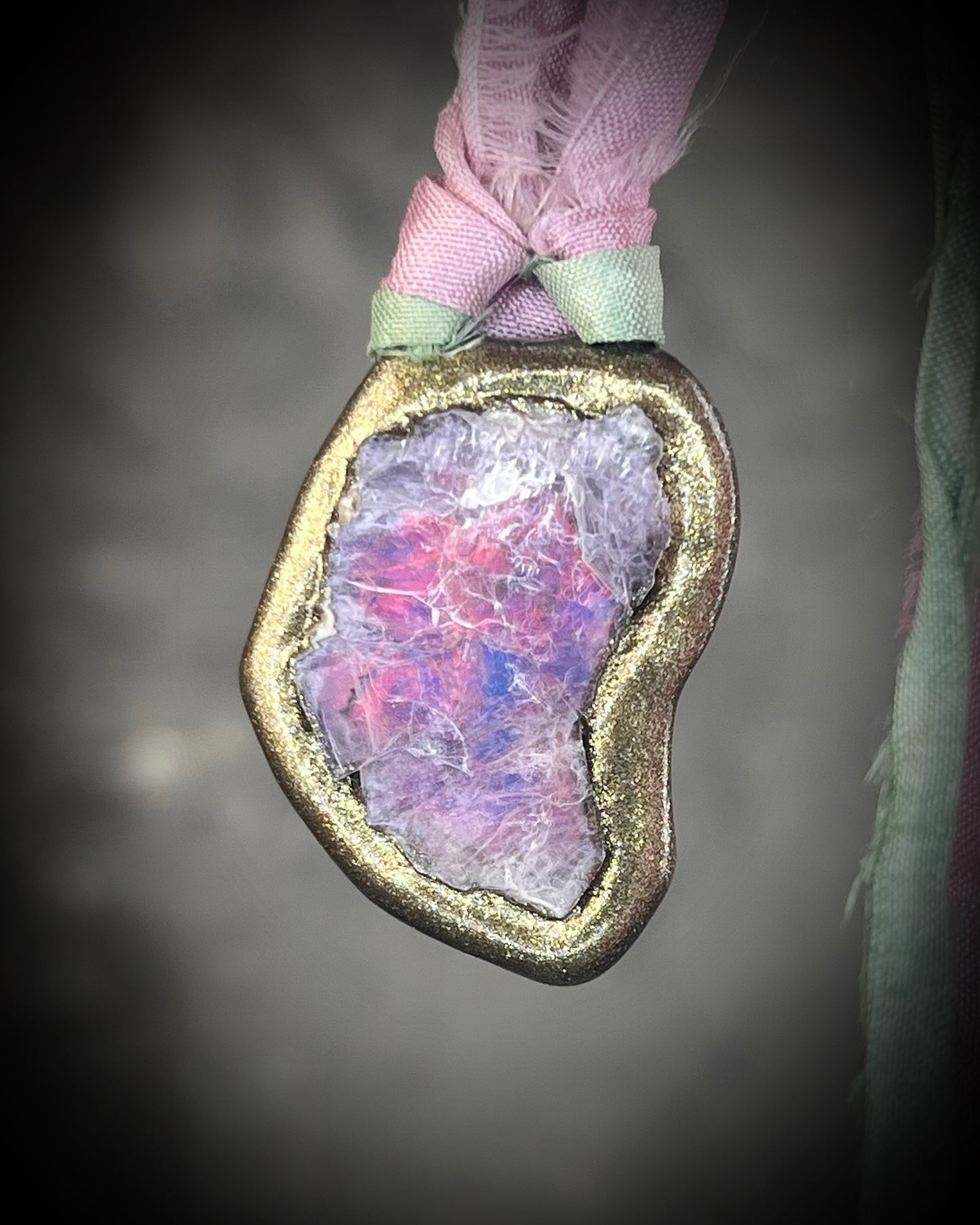 Organic lepidolite crystal talisman  pendant with sculpted gold finish and mint green and lilac recycled silk ties. Handmade by Become Spellbound.