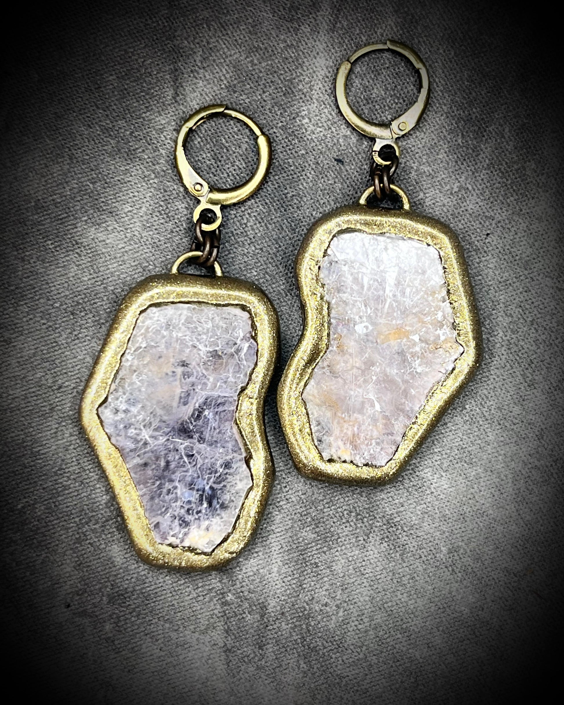 Pair of gold and lepidolite crystal anti-anxiety earrings with natural stone design on a gray background. Gold dangle earrings gift for her! 