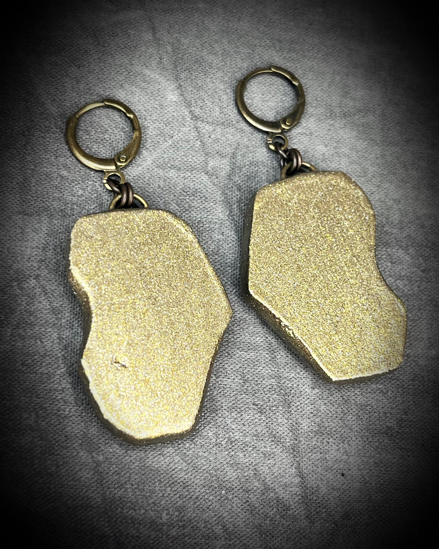 Pair of gold and lepidolite crystal anti-anxiety earrings with natural stone design on a gray background. Holiday handmade jewelry stocking stuffer gift for her!