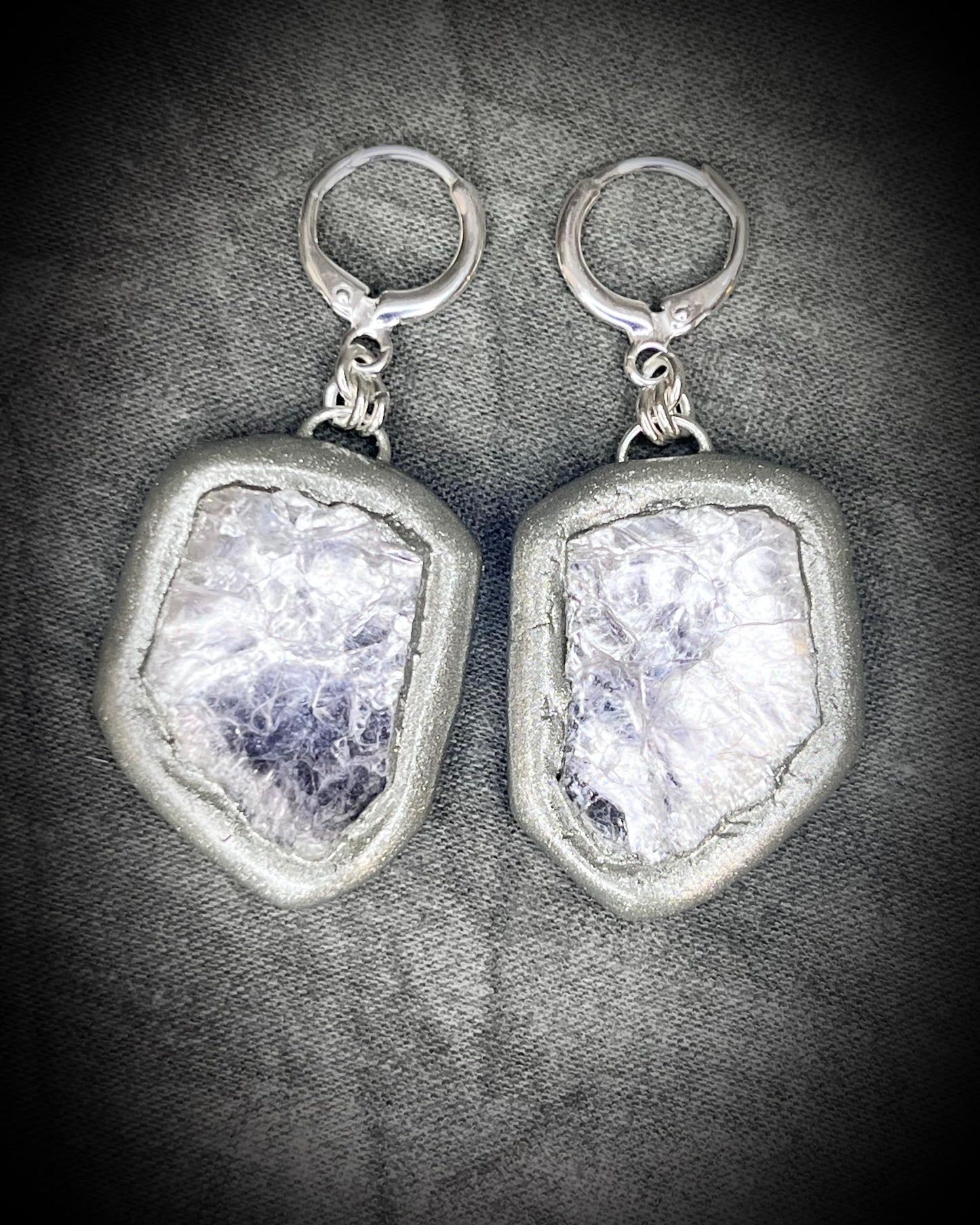 Pair of silver dangle earrings with raw lepidolite crystal gemstones on a dark background. Chunky silver jewelry holiday gift for her. 