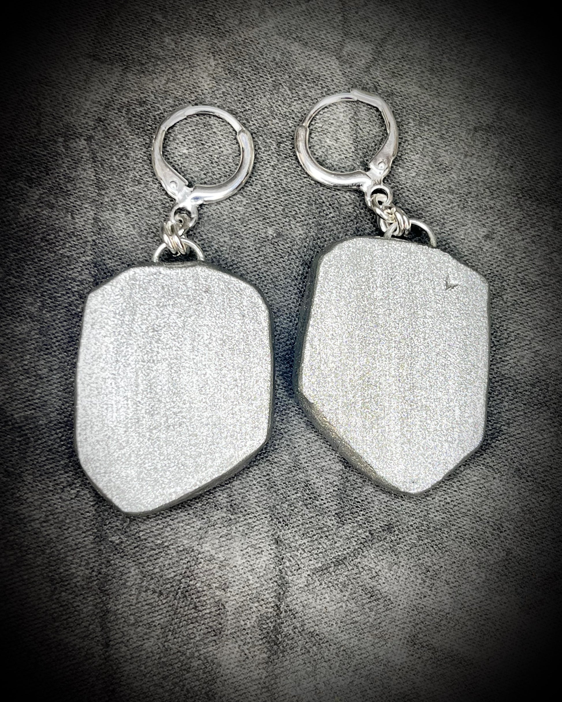 Pair of silver dangle earrings with raw lepidolite crystal gemstones on a dark background. Chunky silver jewelry holiday gift for her. 