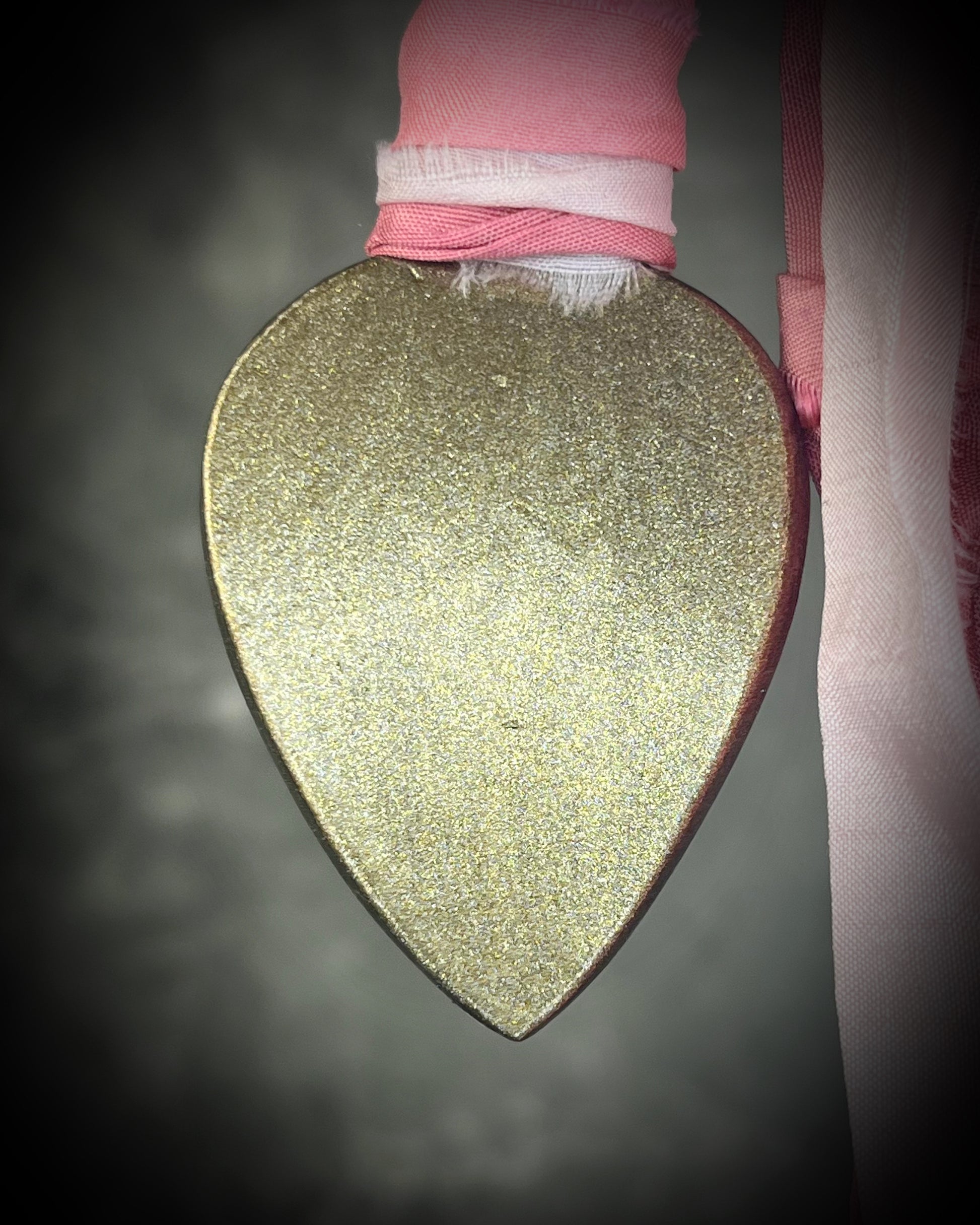 Pink calcite teardrop talisman with sculpted gold finish and ombre pink recycled silk ties. Handmade by Become Spellbound.