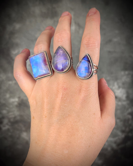 Pink moonstone sterling silver ring with luminous magenta tones and iridescent flash, celestial gemstone jewelry. 
