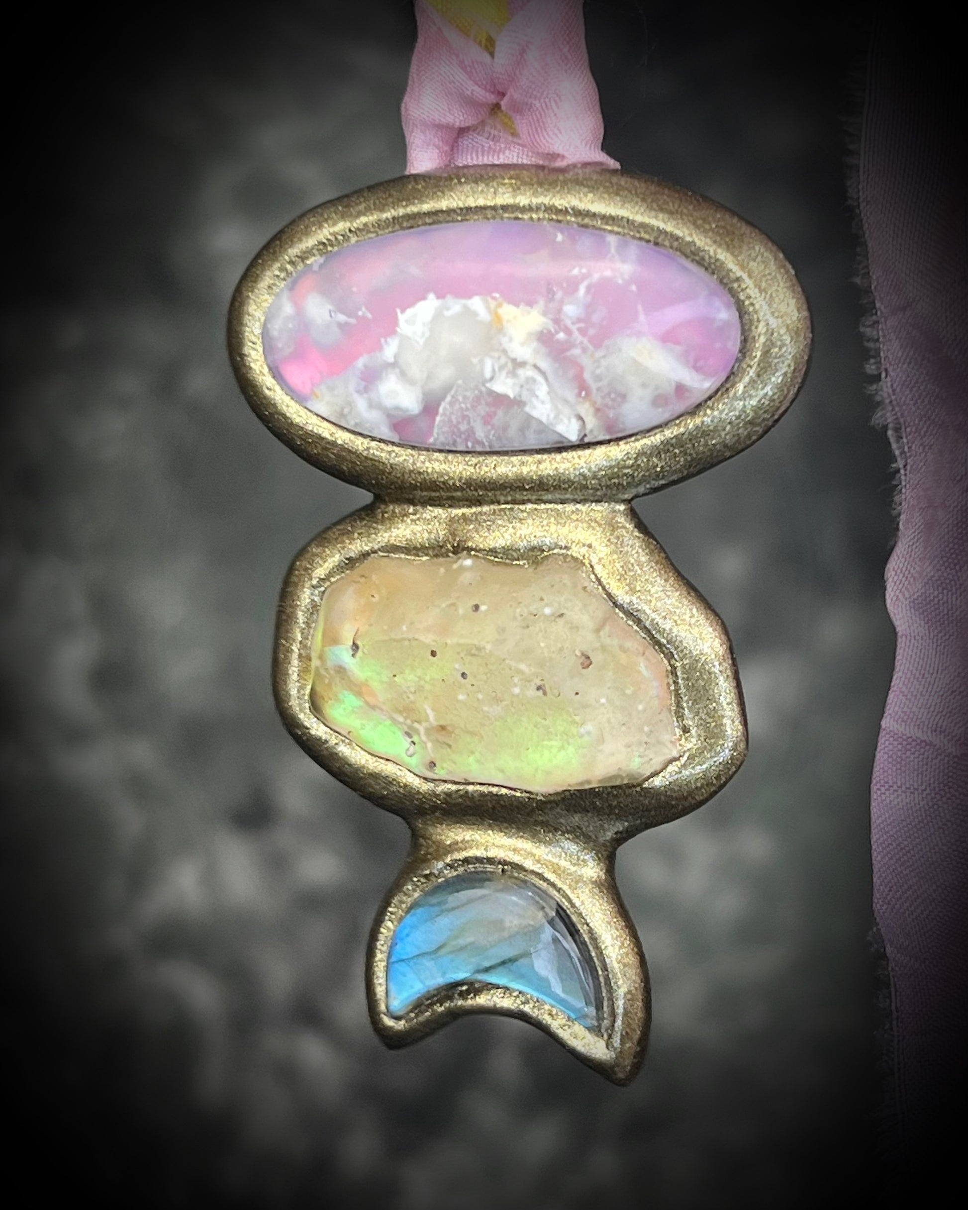 Pink plume agate talisman with Libyan Desert Glass and labradorite moon on pink and yellow recycled silk ties, hand sculpted by Become Spellbound, Baltimore Magazine Best of Baltimore 2026 Jewelry winner.