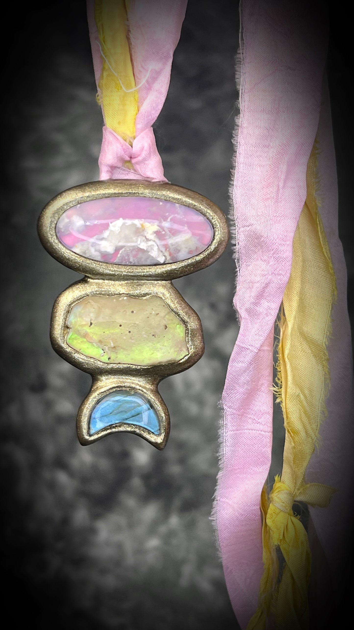 Pink plume agate talisman with Libyan Desert Glass and labradorite moon on pink and yellow recycled silk ties, hand sculpted by Become Spellbound, Baltimore Magazine Best of Baltimore 2026 Jewelry winner.