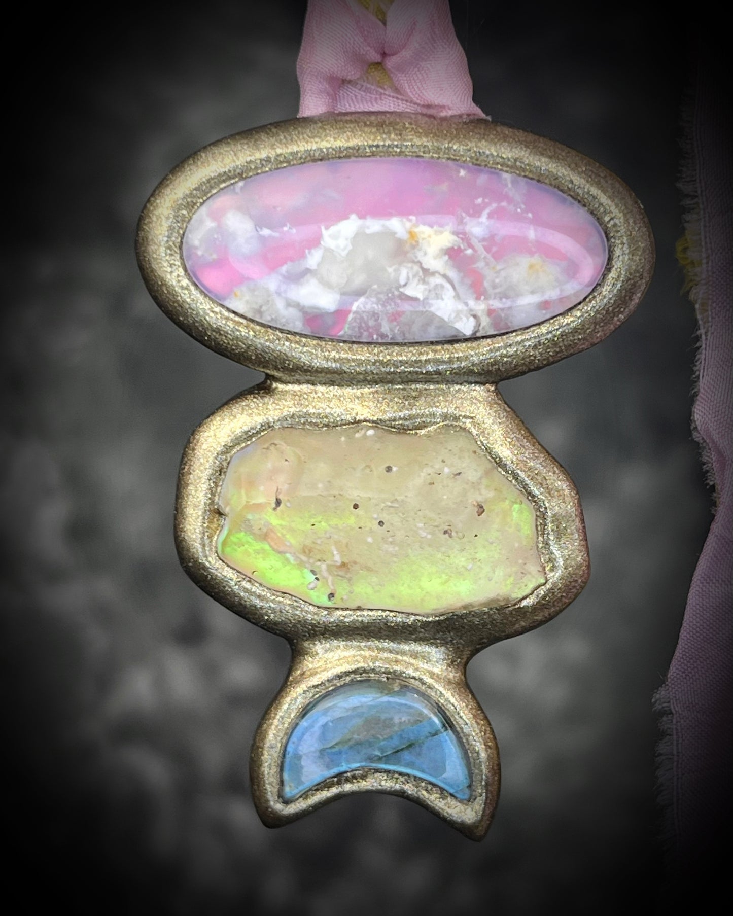 Pink plume agate talisman with Libyan Desert Glass and labradorite moon on pink and yellow recycled silk ties, hand sculpted by Become Spellbound, Baltimore Magazine Best of Baltimore 2026 Jewelry winner.