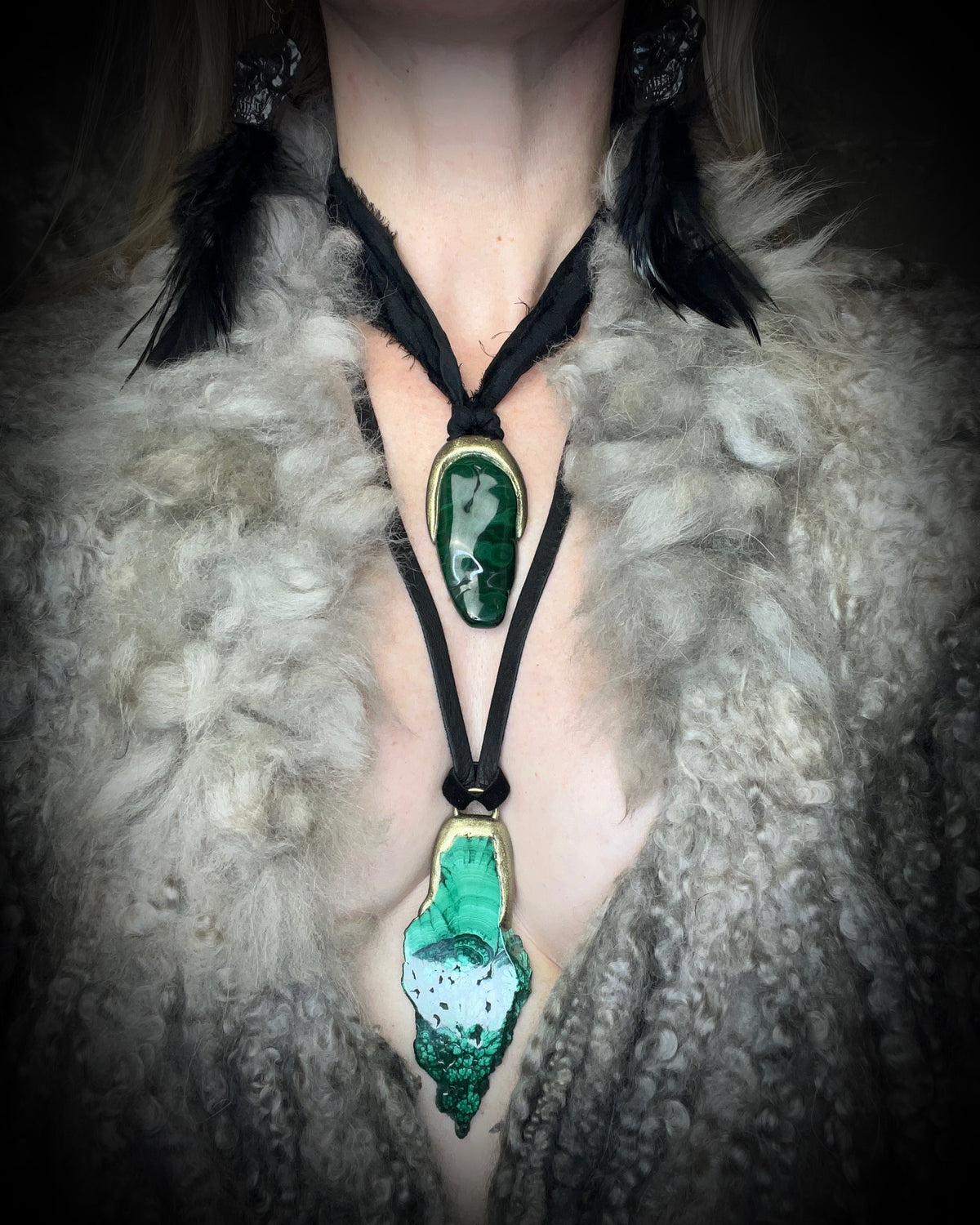 Polished malachite freeform crystal with natural green bands in a sculptural gold-finish talisman setting on black recycled silk, handmade by Become Spellbound in Baltimore, Maryland.