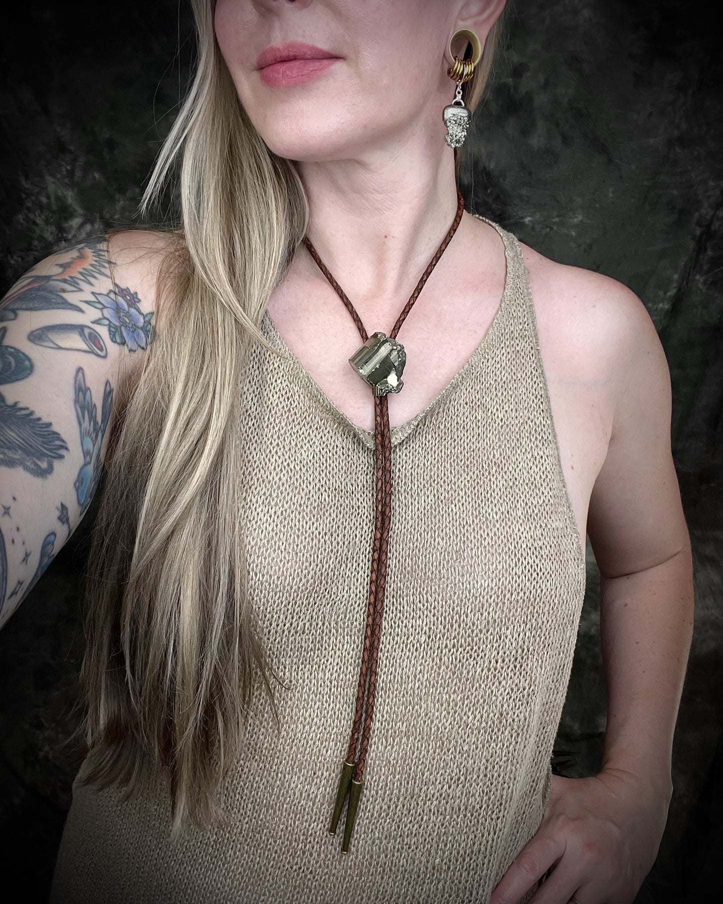 Pyrite bolo tie necklace on brown leather with gold tone finish and brass bolo tips, Western style men’s statement jewelry with natural pyrite crystal, handmade in Baltimore Maryland.