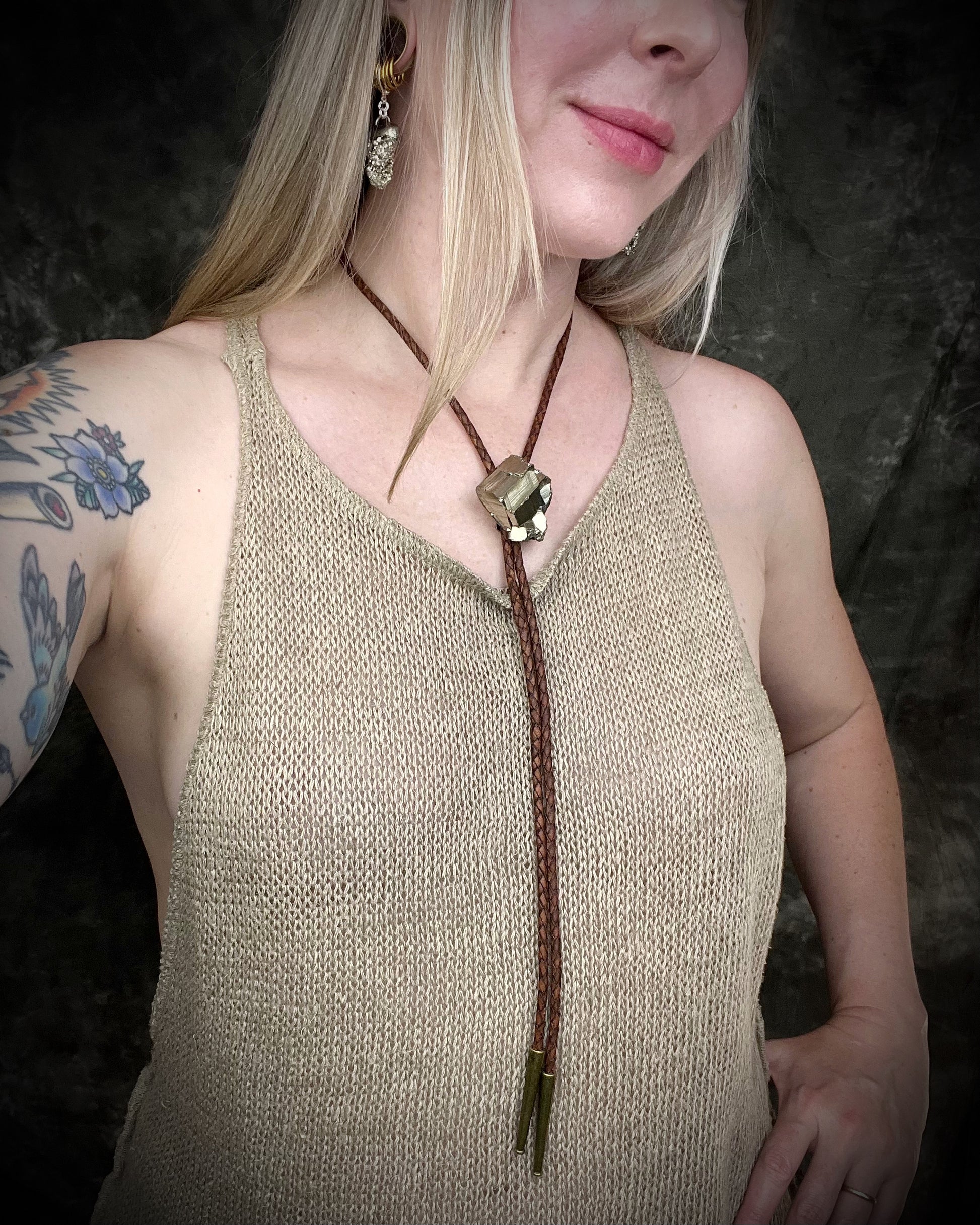 Pyrite bolo tie necklace on brown leather with gold tone finish and brass bolo tips, Western style men’s statement jewelry with natural pyrite crystal, handmade in Baltimore Maryland. 