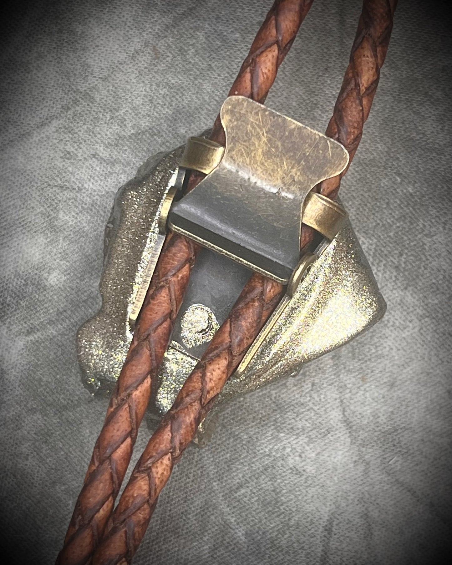 Pyrite bolo tie necklace on brown leather with gold tone finish and brass bolo tips, Western style men’s statement jewelry with natural pyrite crystal, handmade in Baltimore Maryland, Clasp view.